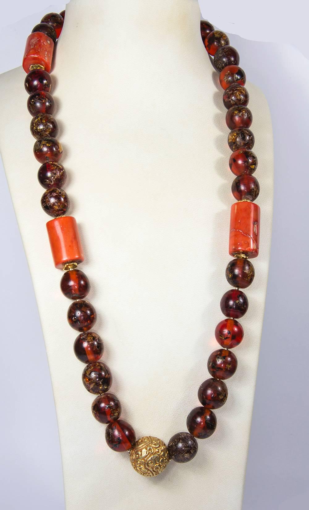 Rare Large Tibetan Natural Copal Amber, Coral and Gold bead Necklace…Beautiful in its simplicity! Length of necklace 35”; 3 coral beads, each approx. 1.25” long x .75” diameter; 36 amber beads; each approx. 19mm-20mm and 1 gilt brass spacer, approx.