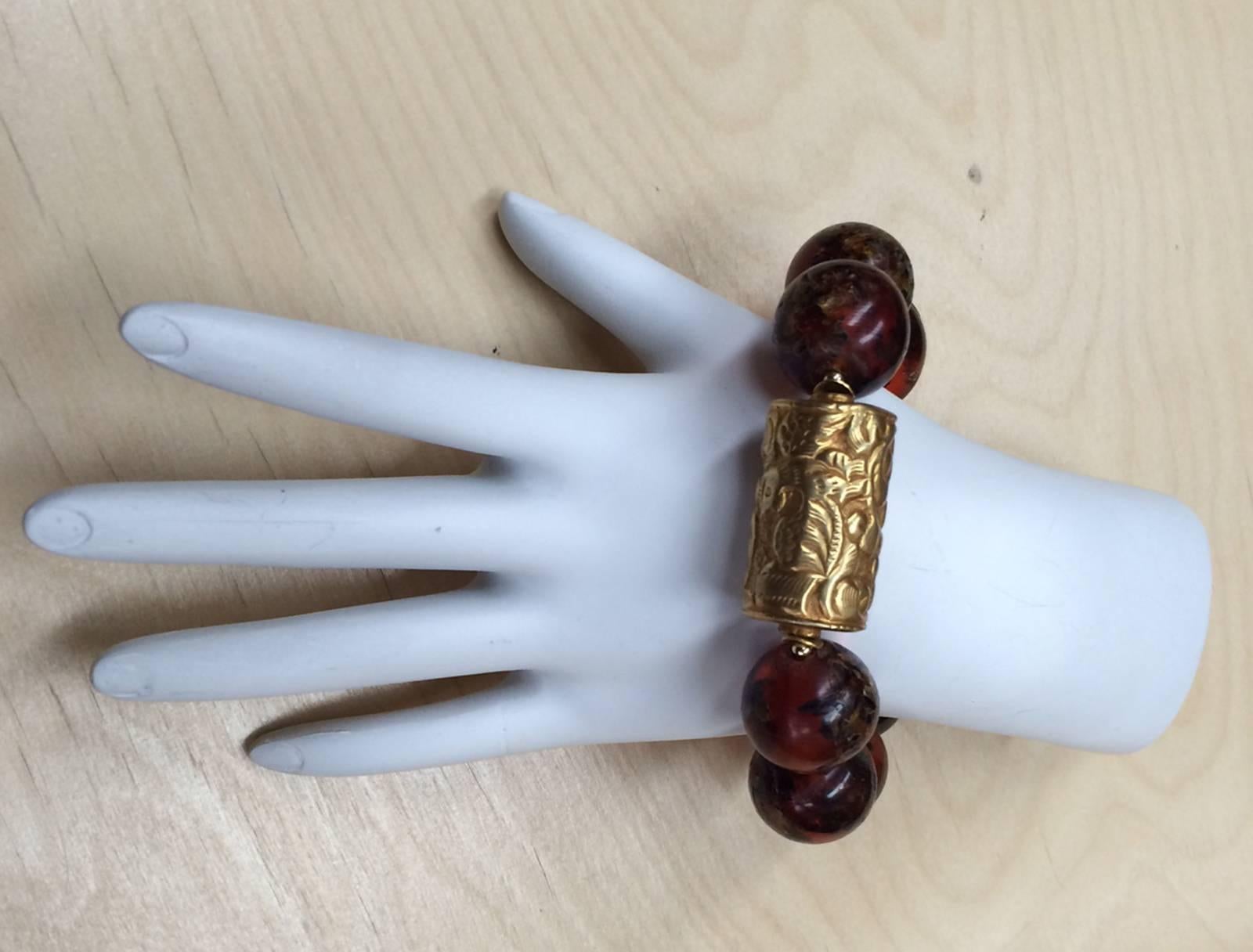 Rare Large Tibetan Natural Copal Amber and Embossed Gilt beads Bracelet...Beautiful in its simplicity! Expandable to fit small-average and plus wrists; 9 amber beads, each approx. 19mm-20mm; accented with gilt S/S spacers, centered by a large