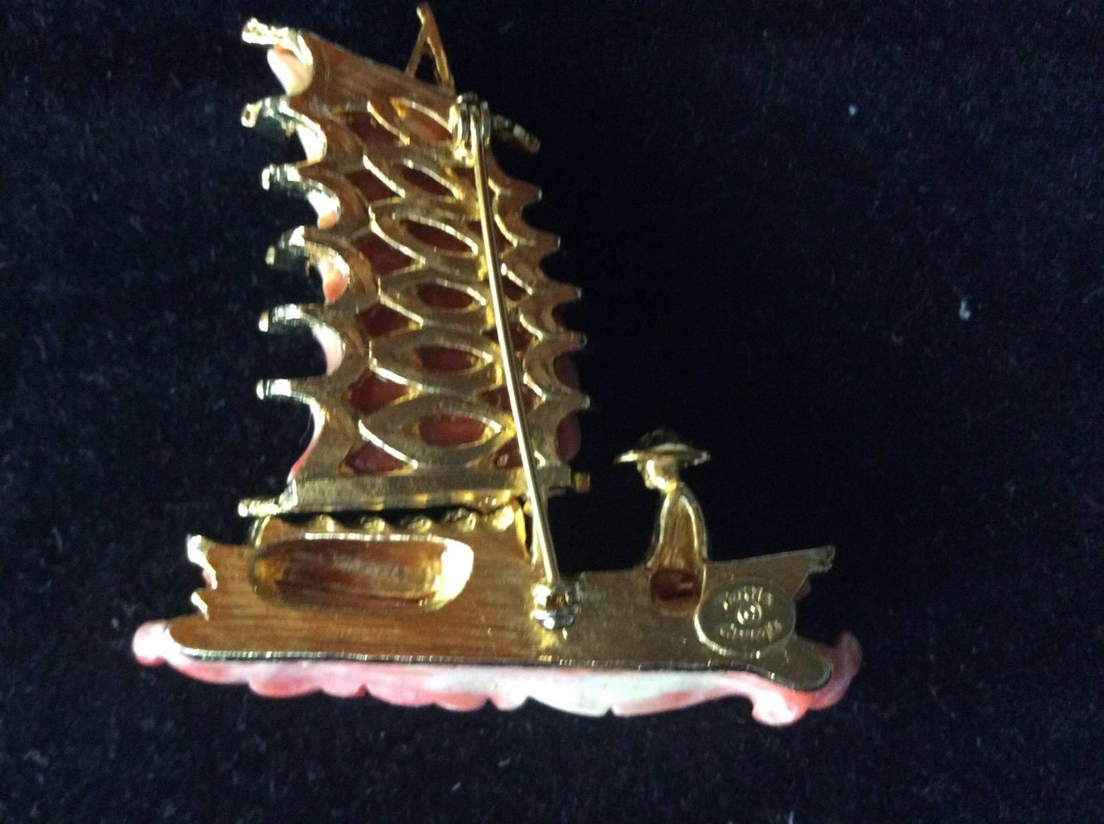 Vintage HATTIE CARNEGIE Chinese Junk Boat Gilt Brooch Pin; Signed on the underside:  HATTIE CARNEGIE in oval cartouche. A perfect complement to every wardrobe… Illuminating your Look with a touch of class! 
