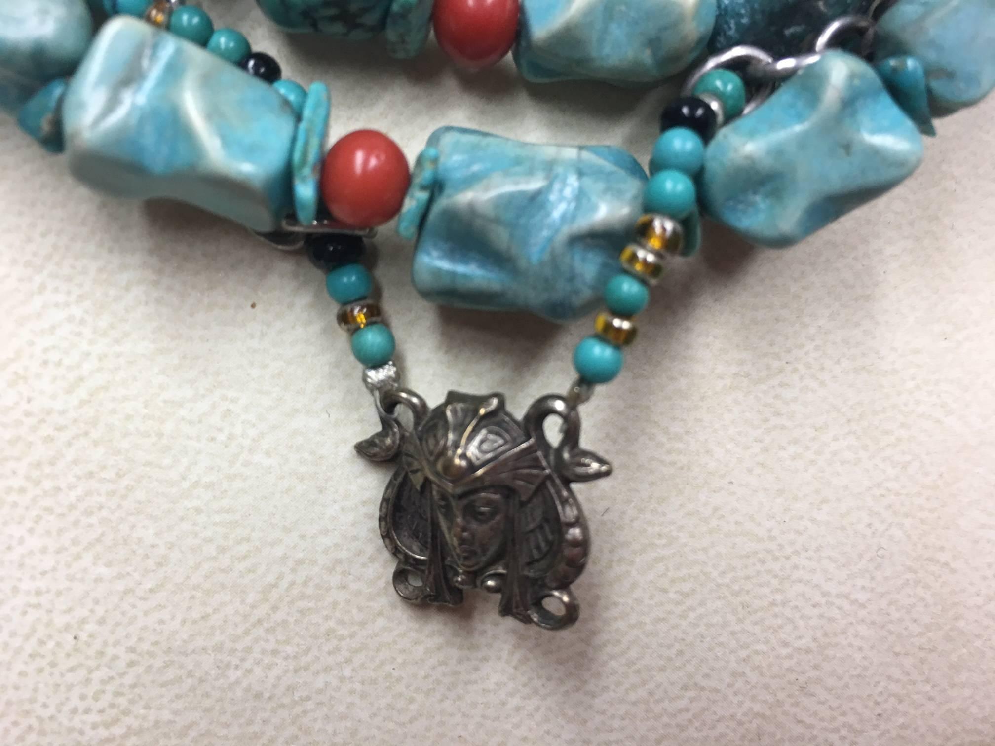 Stunning One-of-a-kind necklace features seven strands of Turquoise; each bead a different shape and size, accented with Coral and Sterling Silver, suspending an Egyptian Goddess pendant; handmade; approx. 17