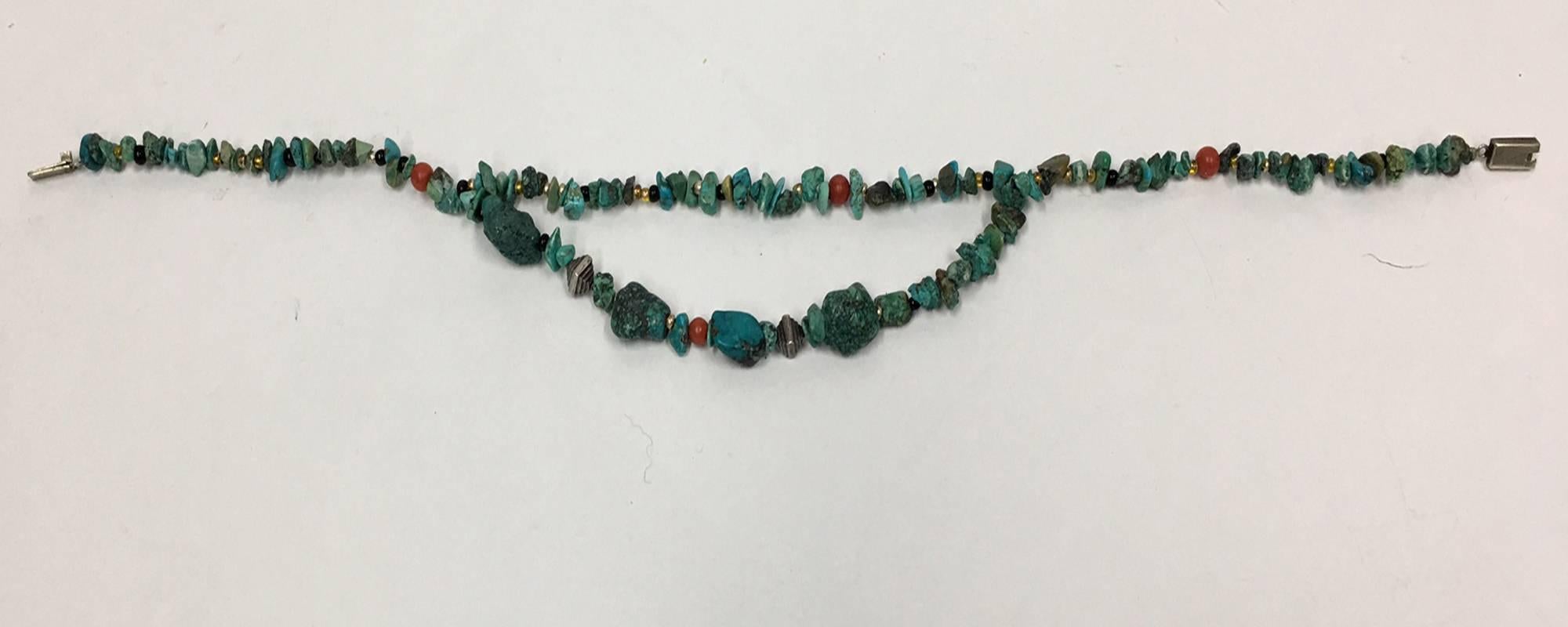 Beautiful necklace features two strands of Turquoise; each bead a different shape and size, accented with Coral and Sterling Silver. Handmade; approx. 15"-17" long. Vintage pieces creatively restyled by Anna K for a striking new look.