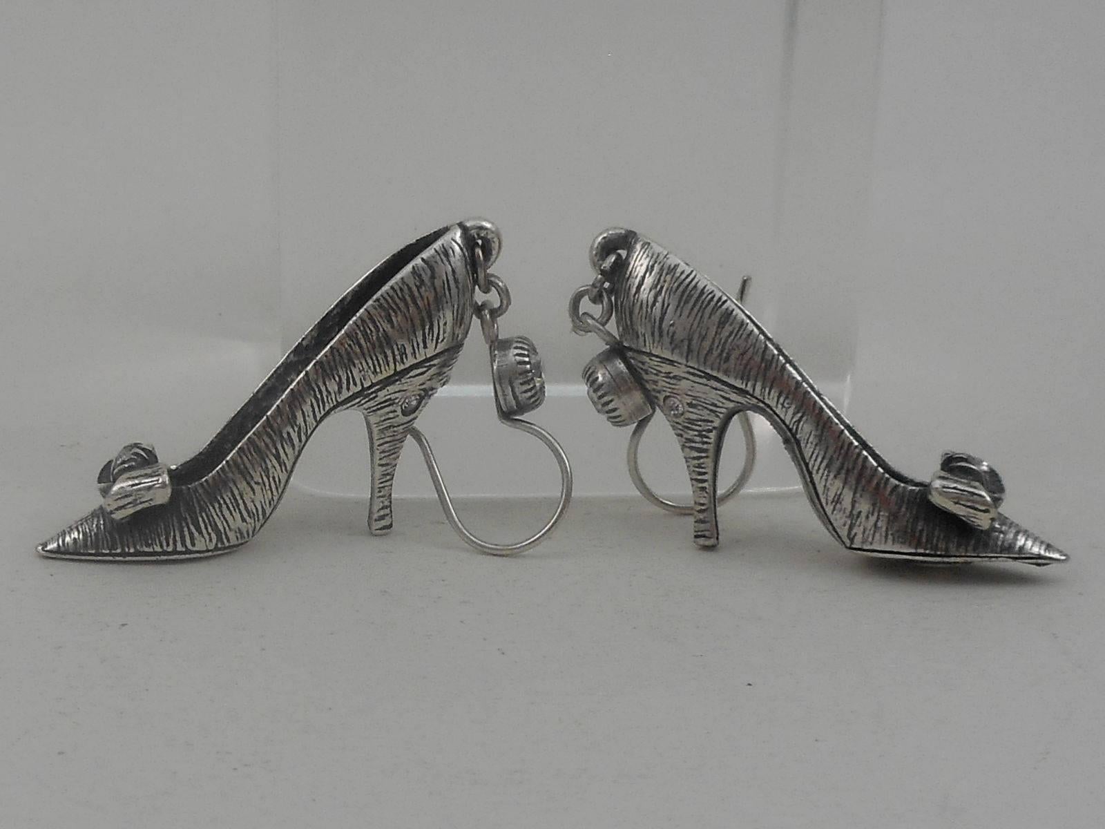 Antiqued Silver Plated Shoes set with Faux Diamonds. Top of earring and shoes set with round a Faux Diamond; further enhanced with Faux Diamonds on heels! Hook earring fittings. Earring measure approx. 2.25'' x 0.25''; Signed: Askew London. An