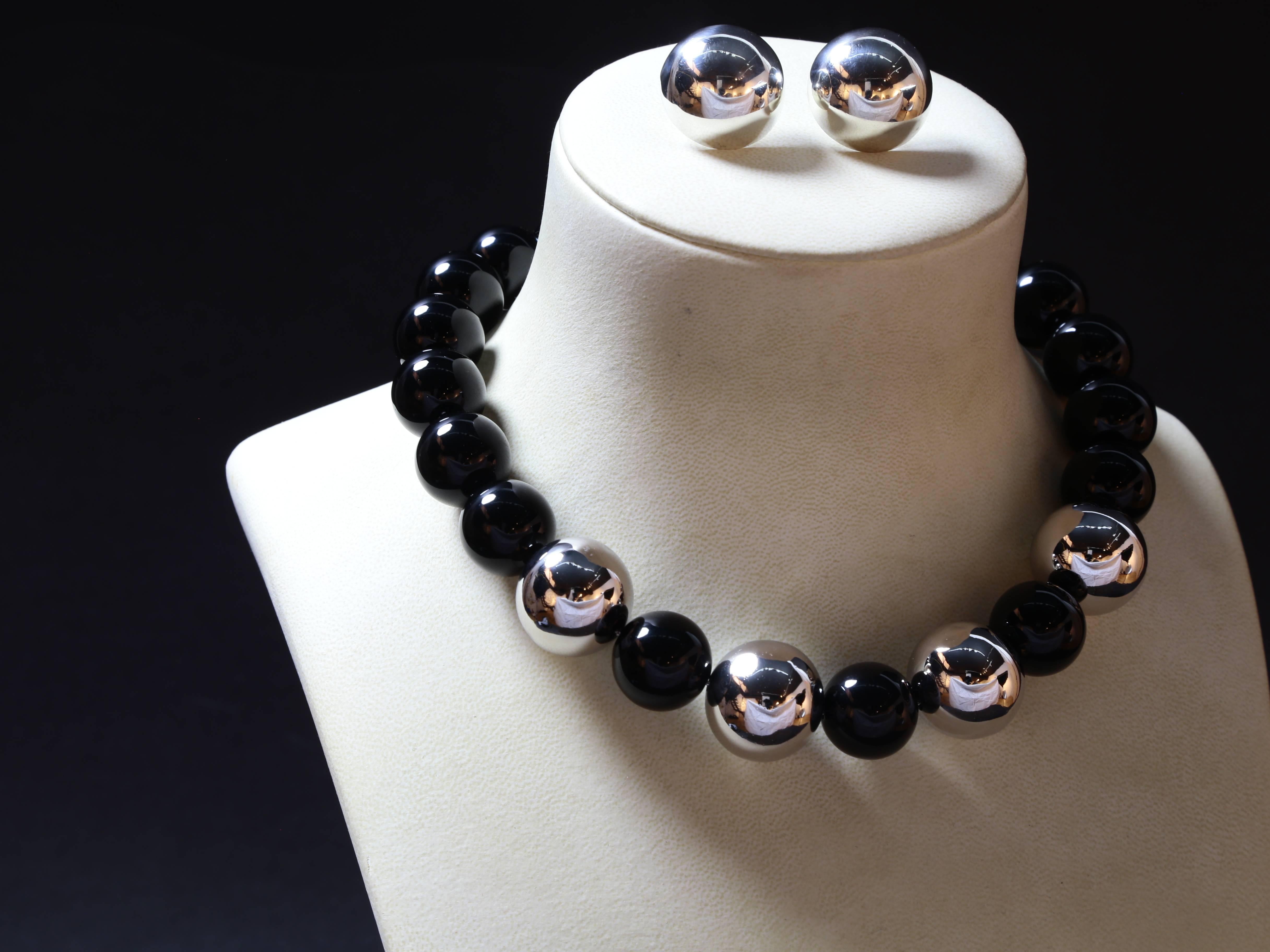Fabulous large black onyx 20 mm bead necklace enhanced with four sterling silver 24 mm. balls, rhodium plated to prevent tarnishing; attached with sterling silver lobster claw. The necklace accompanied by a co-coordinating pair of large sterling
