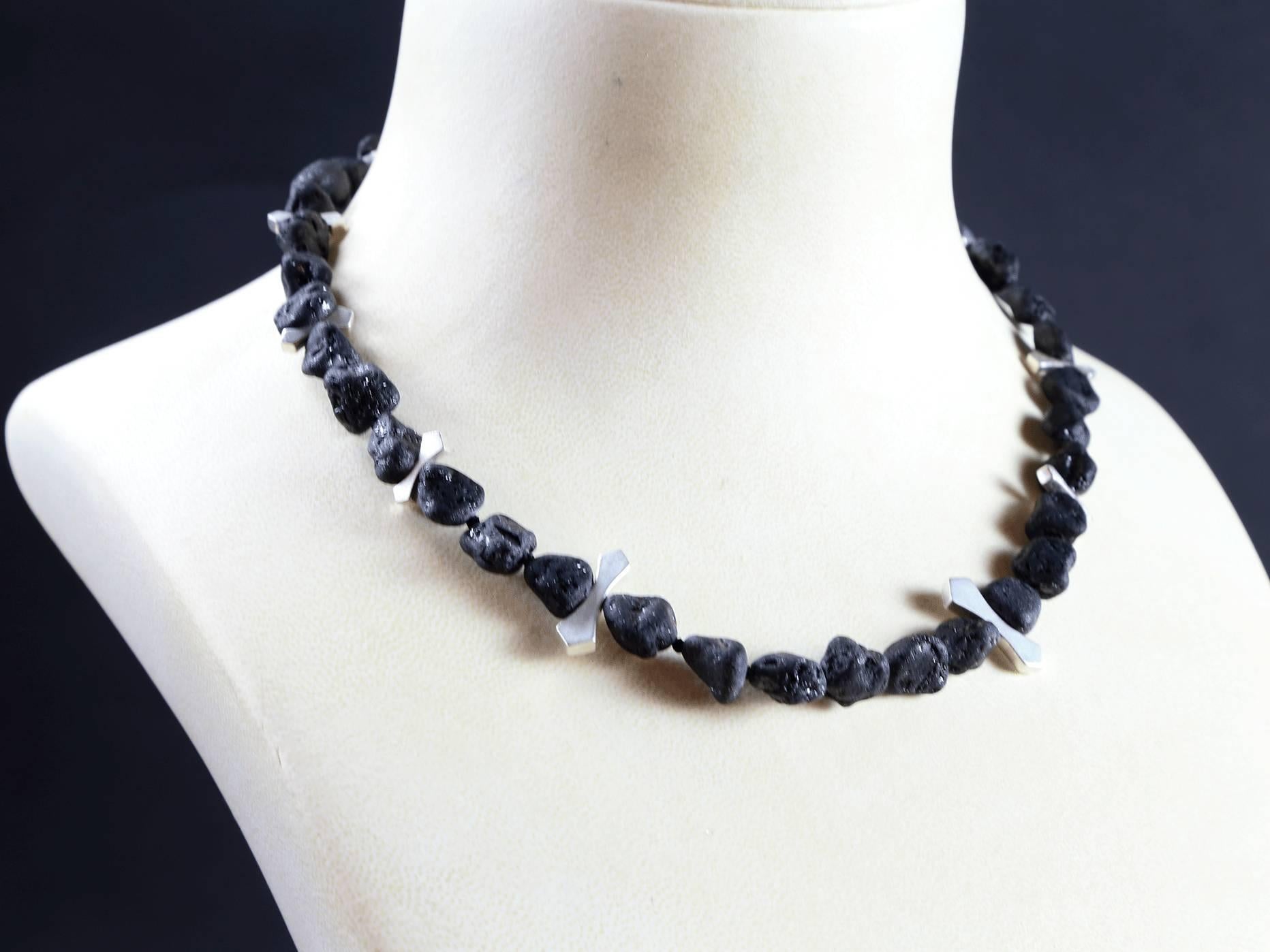 Beautiful Natural black lava nugget necklace. The hand knotted nuggets are inter-spaced with sterling silver tablets, and fastened with a sterling silver double-S hook.  Lava is known for its healing properties endowed through its close proximity to