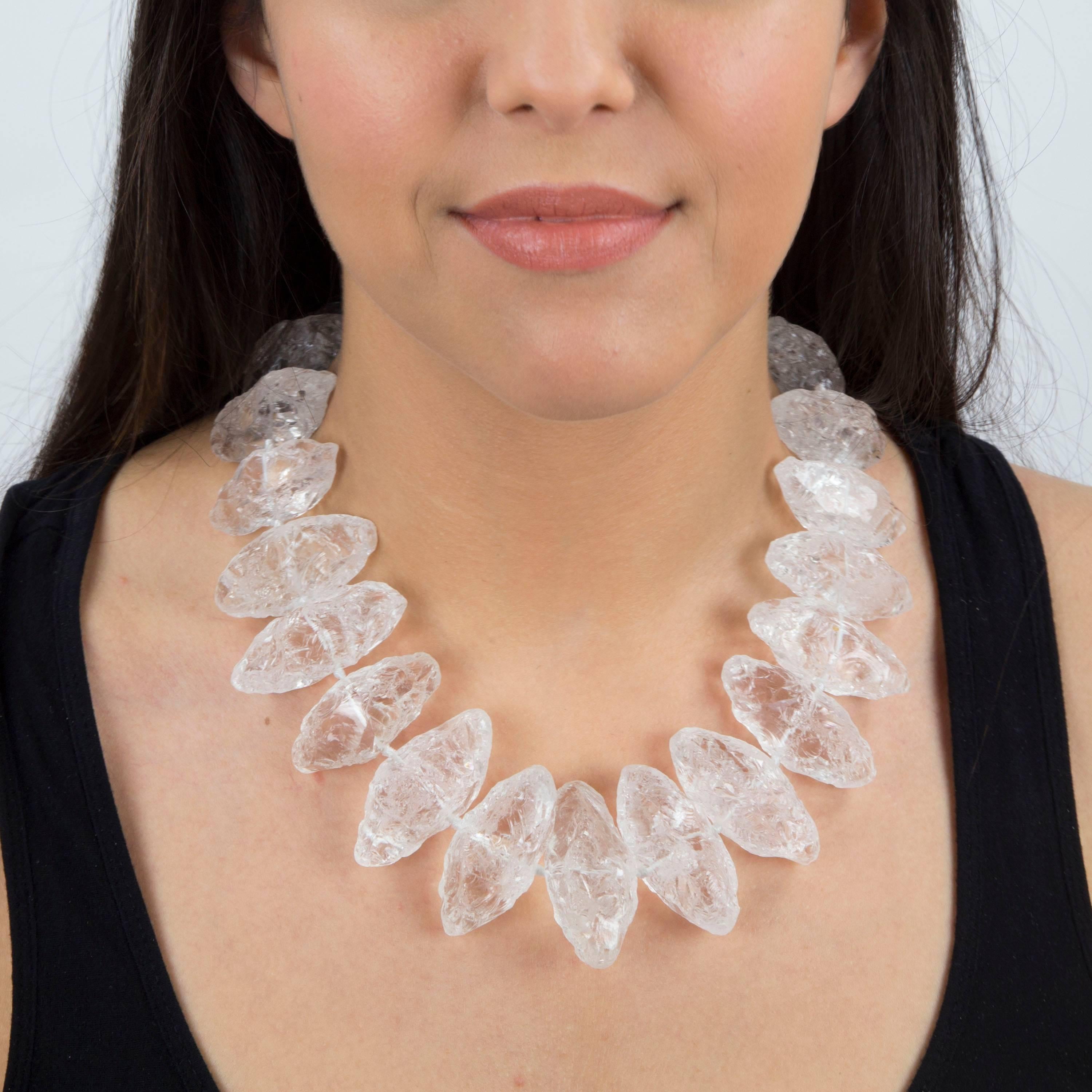 Dynamic Handmade Runway Necklace featuring pear shaped Natural Rock Crystal Gemstones held by a Gilt Sterling Silver clasp. Slightly graduated, each crystal measures approx. 41.5mm-48.5mm. Hand knotted on white silk cord. The beauty of these rock