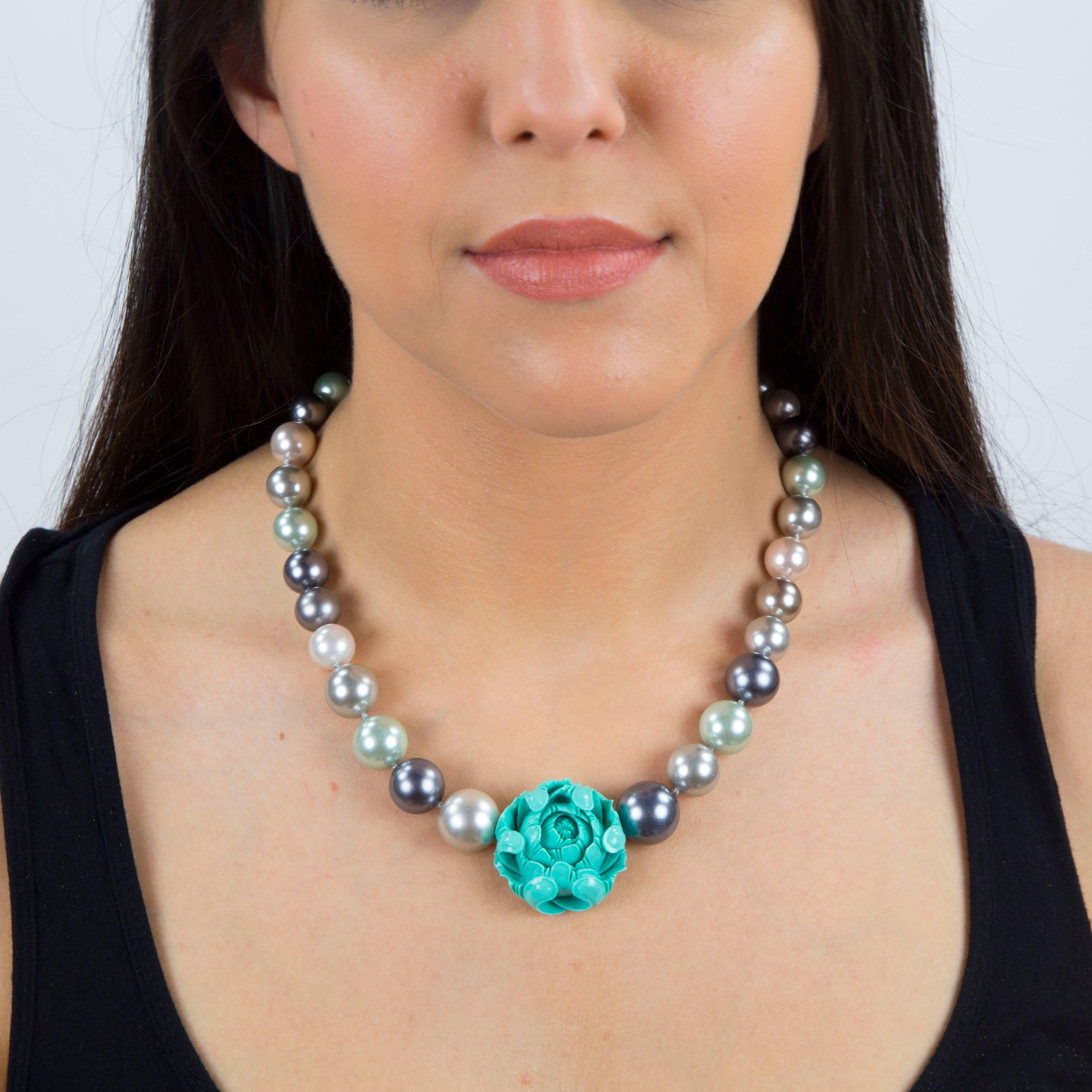 One-of-a-Kind large Faux Pearl Necklace with Beautiful hand carved genuine Turquoise Flower, measuring approx. 1.25” in diameter, length of necklace, held by a gilt sterling silver clasp: 18”. 
 I’m constantly inspired by the places I visit and the