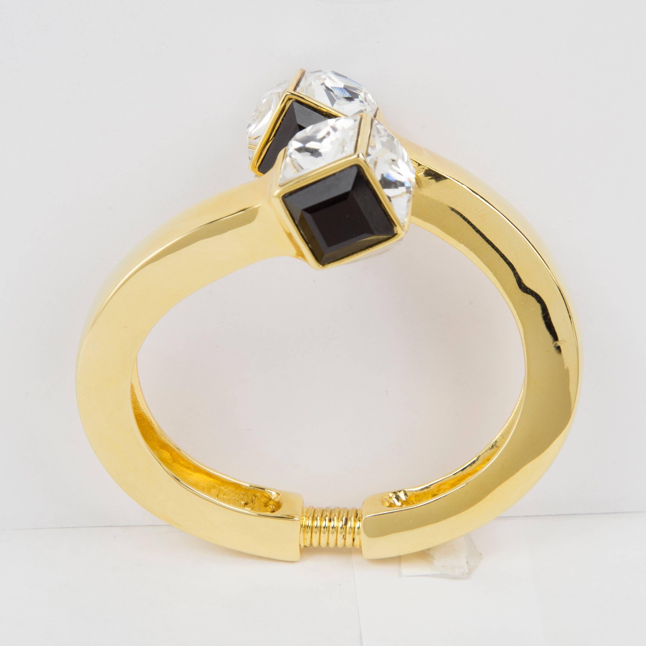 Stunning Kenneth Jay Lane Crossover Cuff Bracelet set with Sparkling Square Black and Clear Faux Diamonds; signed: KJL; approx. interior dimensions: 2.25” x 1.88”; Signed: KJL. Never worn. Outstanding...Add Pizazz to any Outfit!
