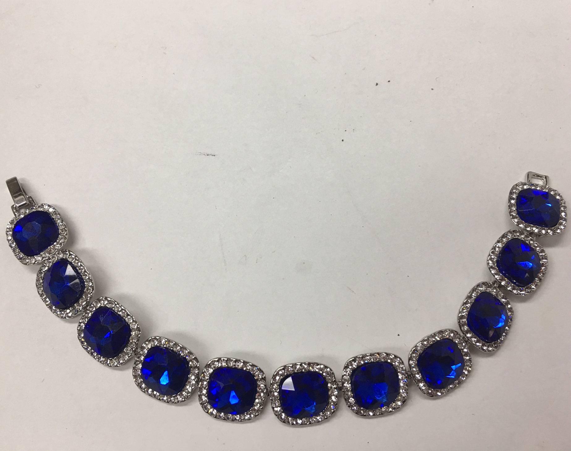 Exceptional Look of Fine Jewelry Sparkling Blue Sapphire Glass and Crystal Heavy Runway Bracelet; Silver tone metal; fold over Clasp. Approx. 7.5 Inches long; A perfect complement to every wardrobe…Illuminating your Look with a touch of Class!
