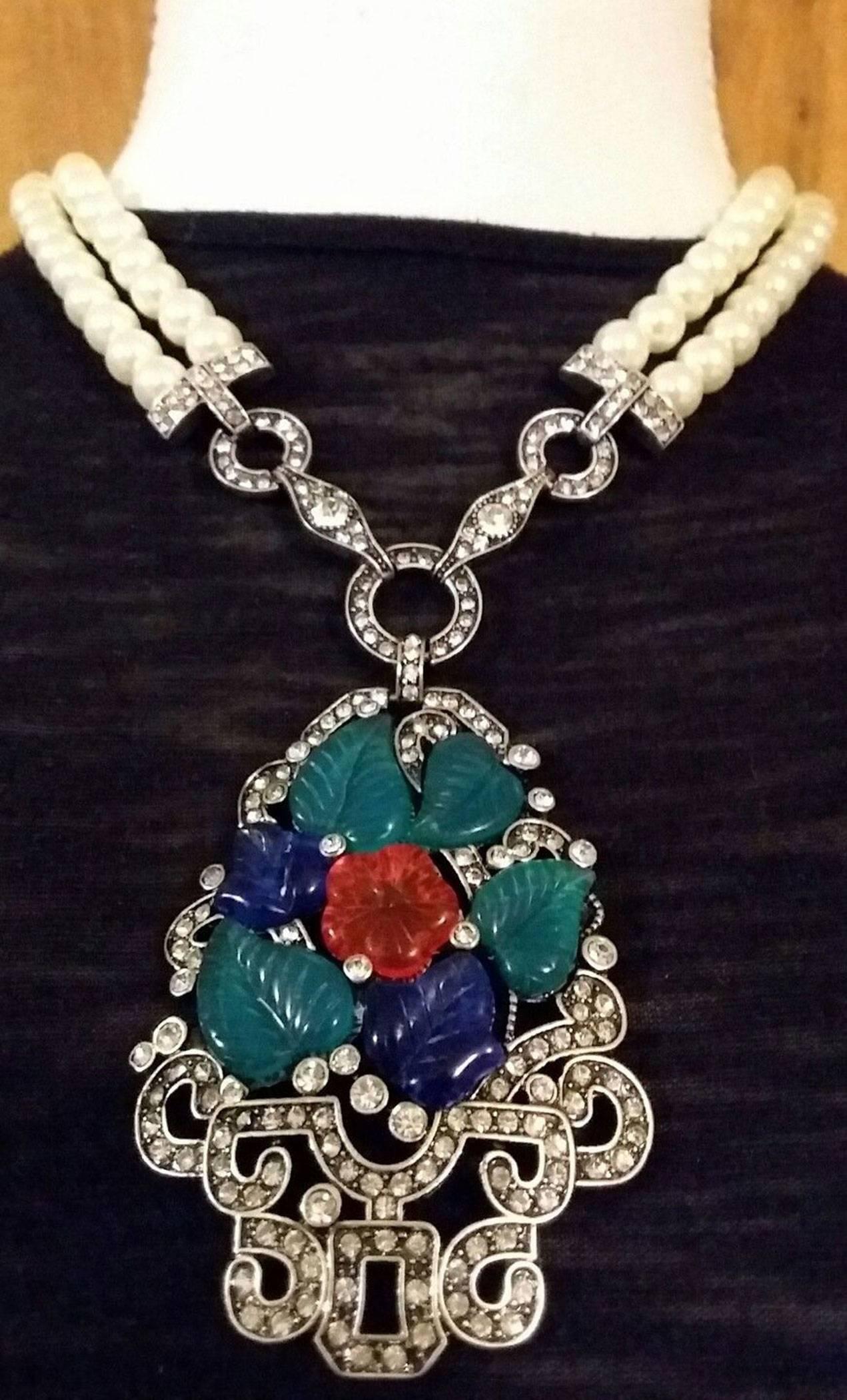 Art Deco Style Statement Necklace featuring Fruit Salad and Leaves Pendant accented by Faux Sparkling Faux Diamonds suspended from double strand of Faux Pearls. Adjustable length: 19 inches- 22 inches; plus pendant measuring approx. 4.5 inches; Add