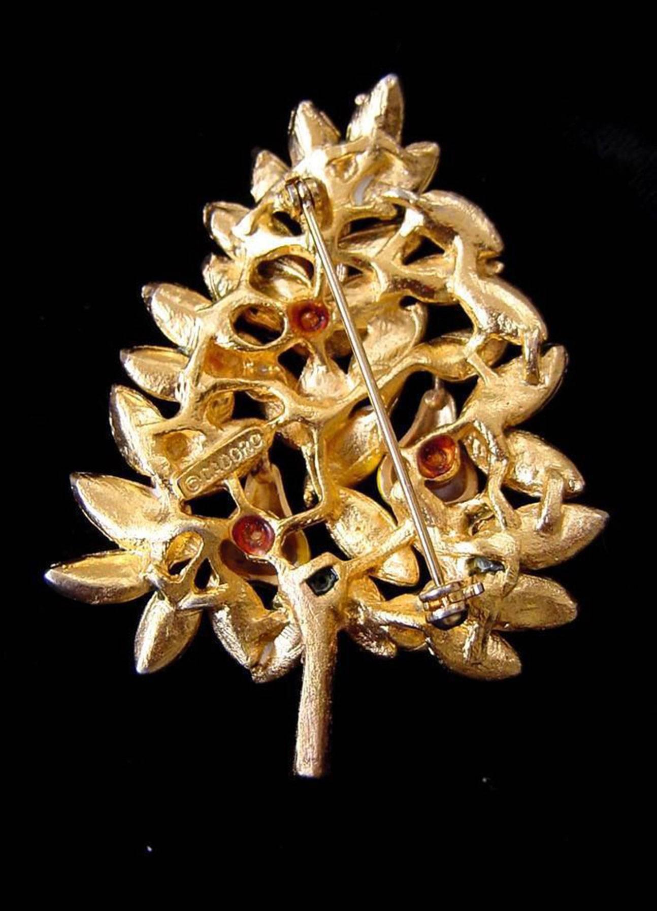 Delightful Christmas pin signed by Cadoro, features a Faux Diamond Partridge in a gold tone tree with enamel green leaves and yellow enamel pears. signed: CADORO. Add your own Chic Festive Style and Pizzazz to any outfit! 
