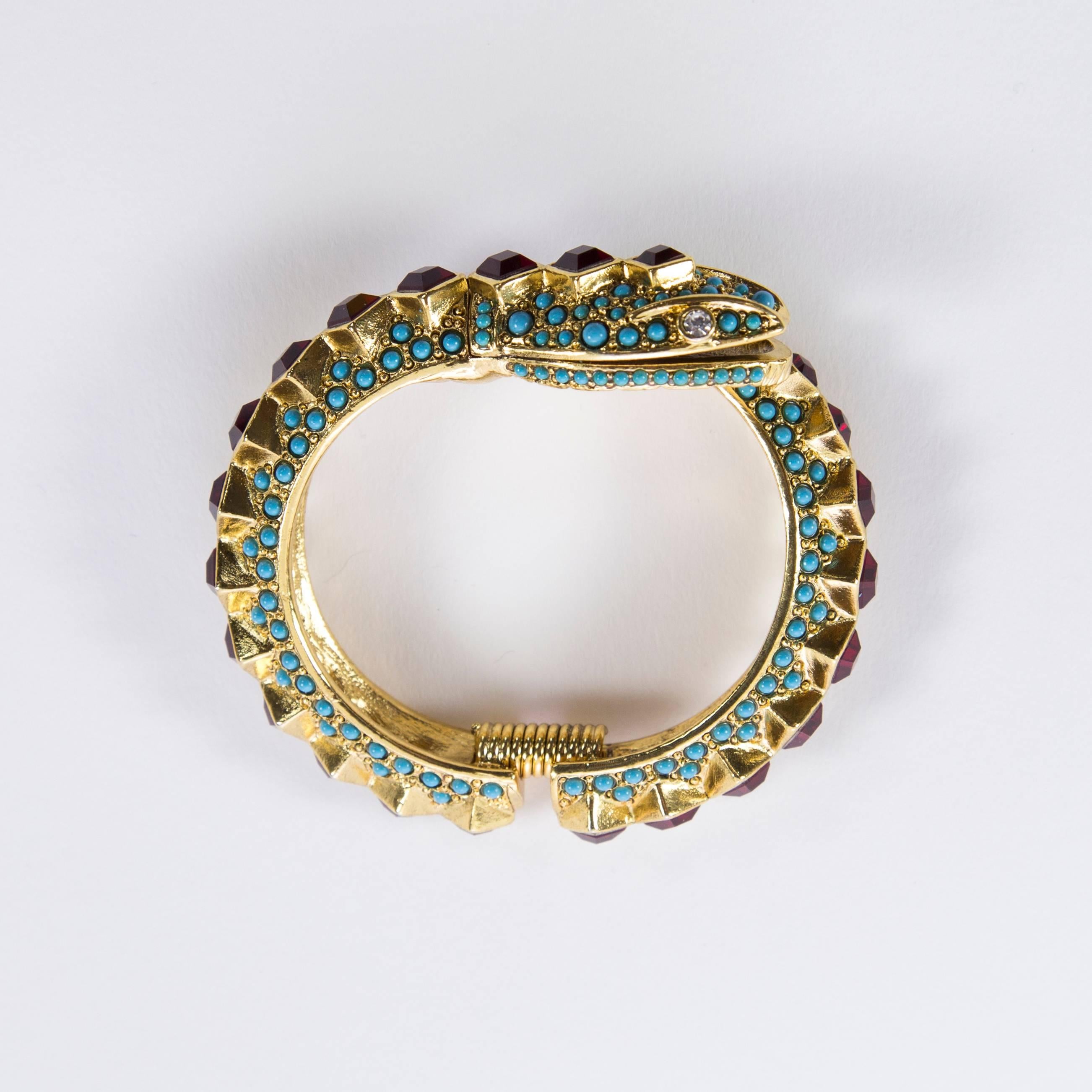 Fabulous Wrap around Snake Hinged Cuff Bracelet encrusted with Sparkling Faux Rubies and Faux Turquoise; signed on reverse: KENNETH LANE MADE IN USA; approx.  .75” wide; Classic, Stylish, Beautiful and Fun to Wear! See our matching Collar Necklace. 
