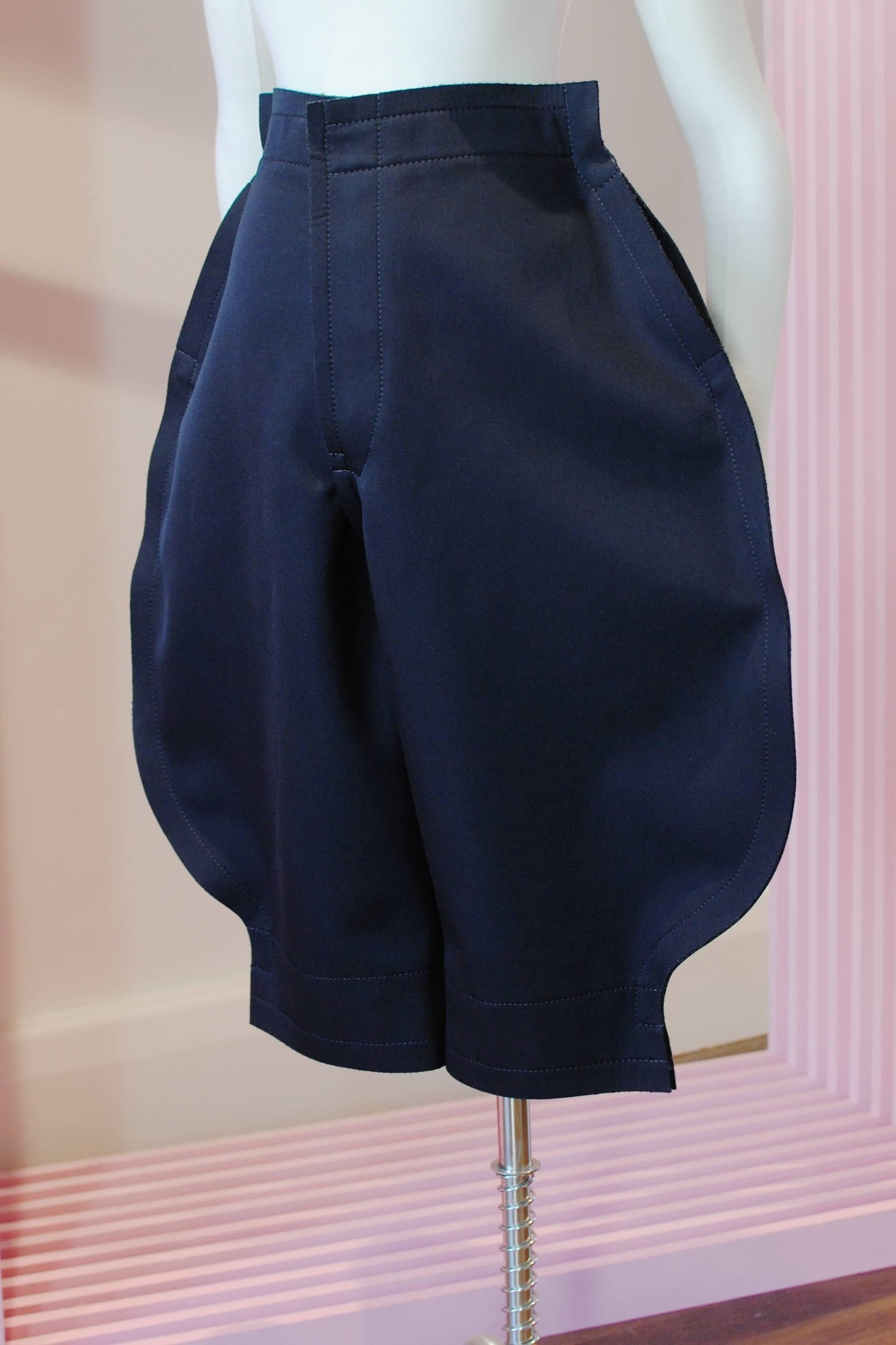 COMME des GARÇONS navy 2D breeches from the 2012 Autumn/Winter collection. They feature a 2D design, two waist level pockets and a thick two layered fabric with a wool gabardine outer and a polyester backing that gives the fabric its