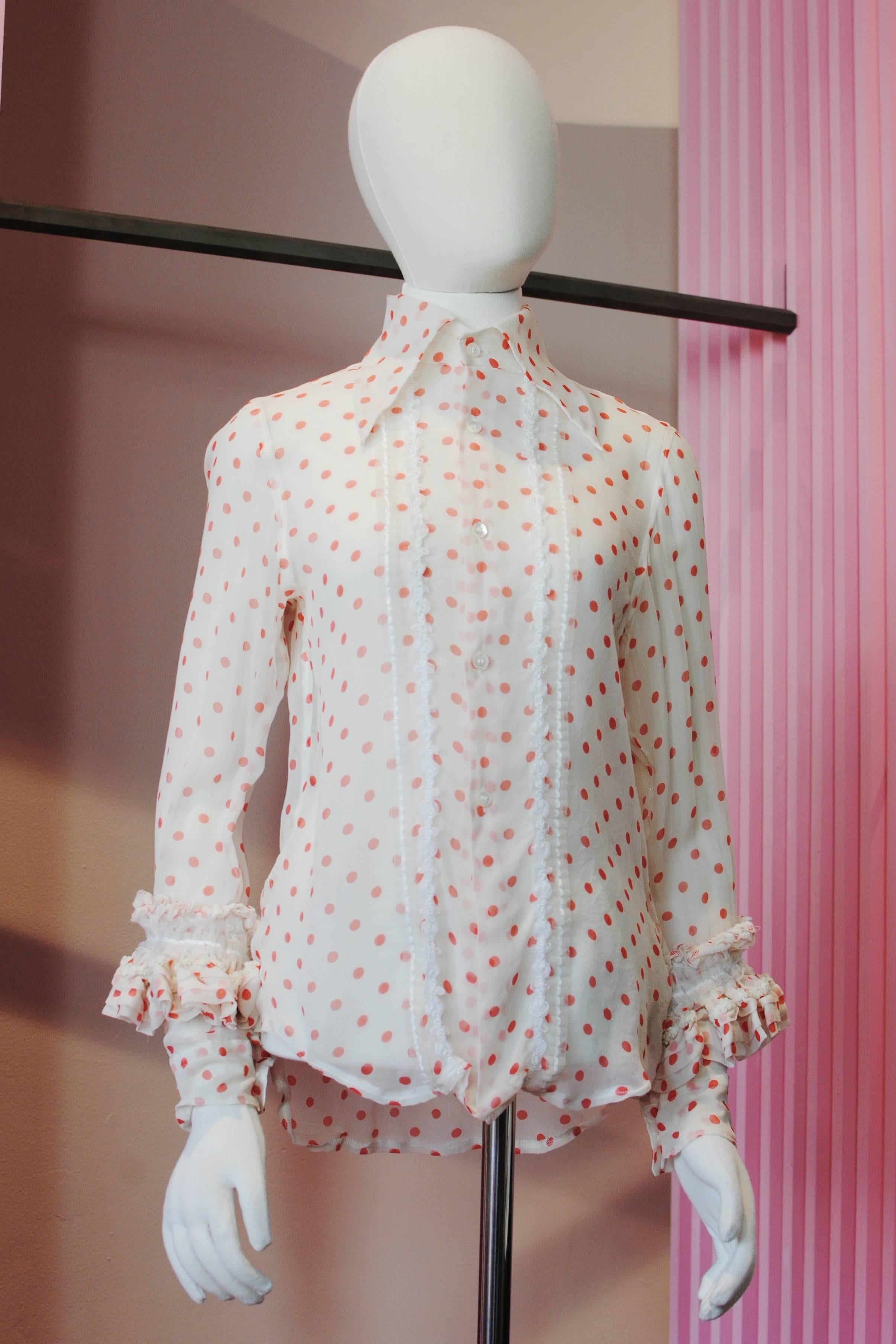 COMME des GARCONS silk polka dot shirt from the 2006 Autumn/Winter collection. It features silk crepe fabric with a red and white polka dot design. The sleeves are decorated with ornate ruffled bands.

Size — Small
Shoulder — 39 cm
Chest — 45