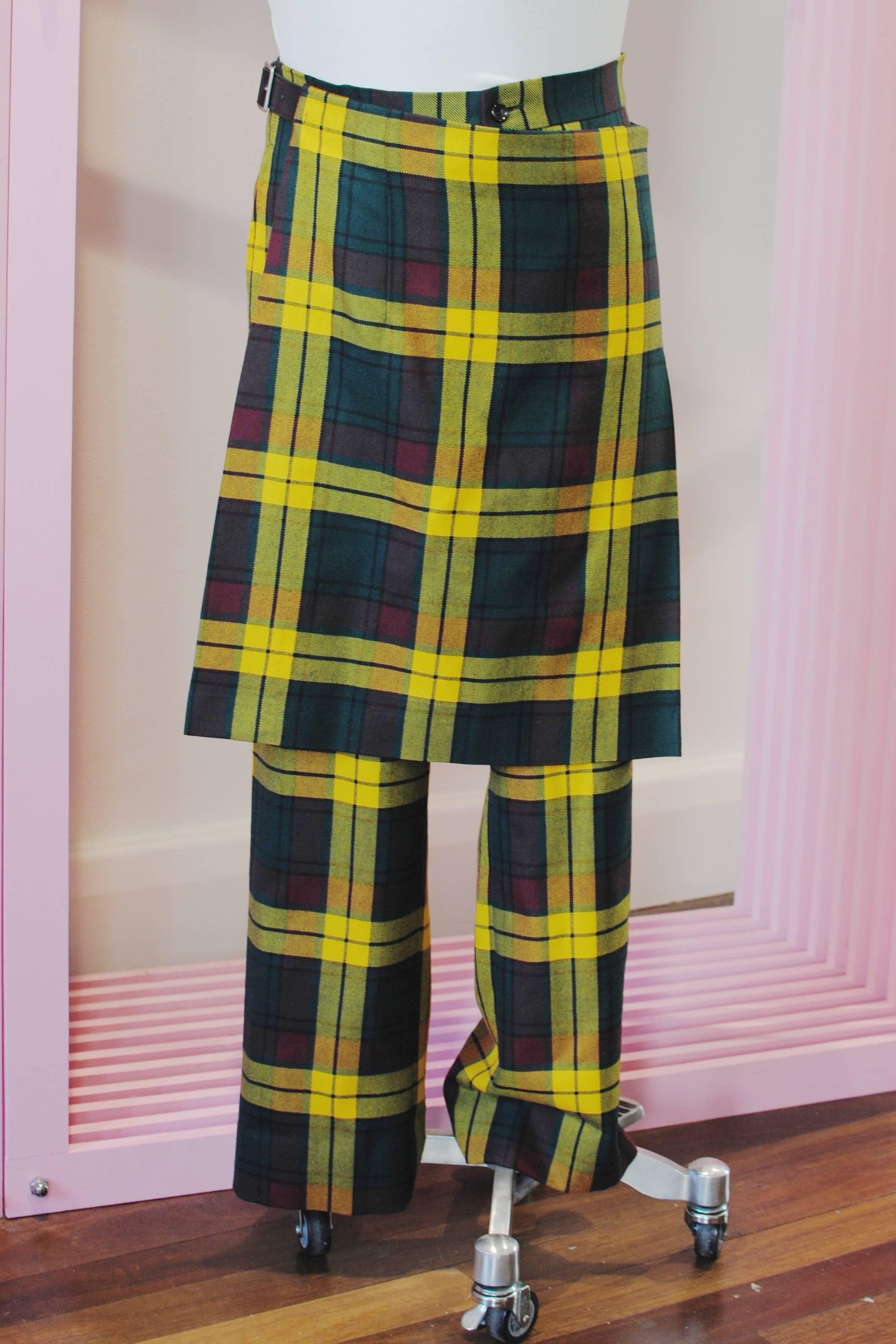 COMME des GARÇONS  Homme Plus plaid kilt pants from the 2004 Autumn/Winter collection. They feature a kilt with two leather belt fasteners, two waist level pockets, one back pocket and plaid wool fabric.

Size — Medium
Waist — 86 cm
Rise — 28