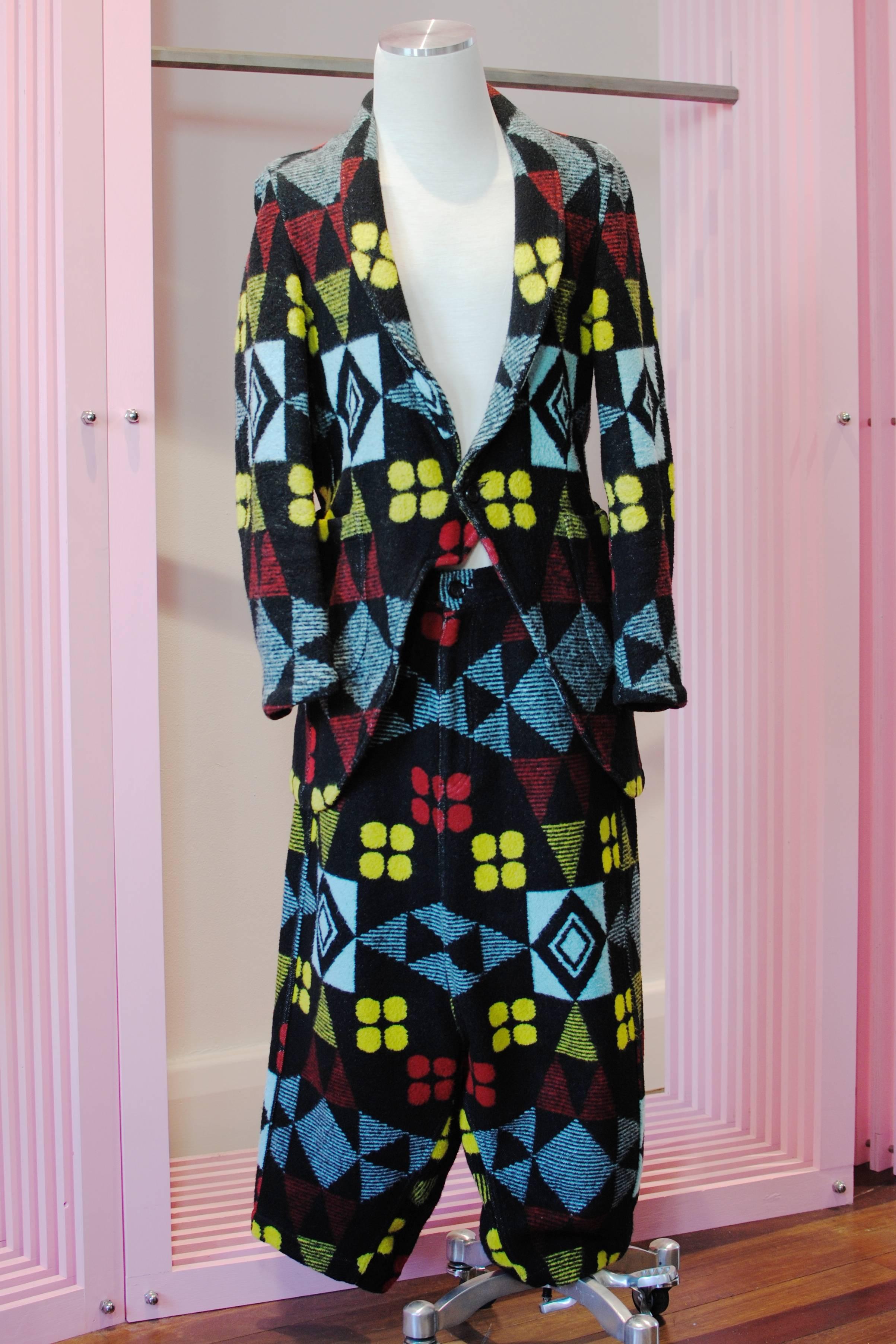 COMME des GARÇONS Homme Plus tribal print blanket suit from the 2004 Autumn/Winter collection. The jacket features a notched lapel, one button fastening, full length sleeves, two waist level pockets, one chest height pocket and two inside pockets.