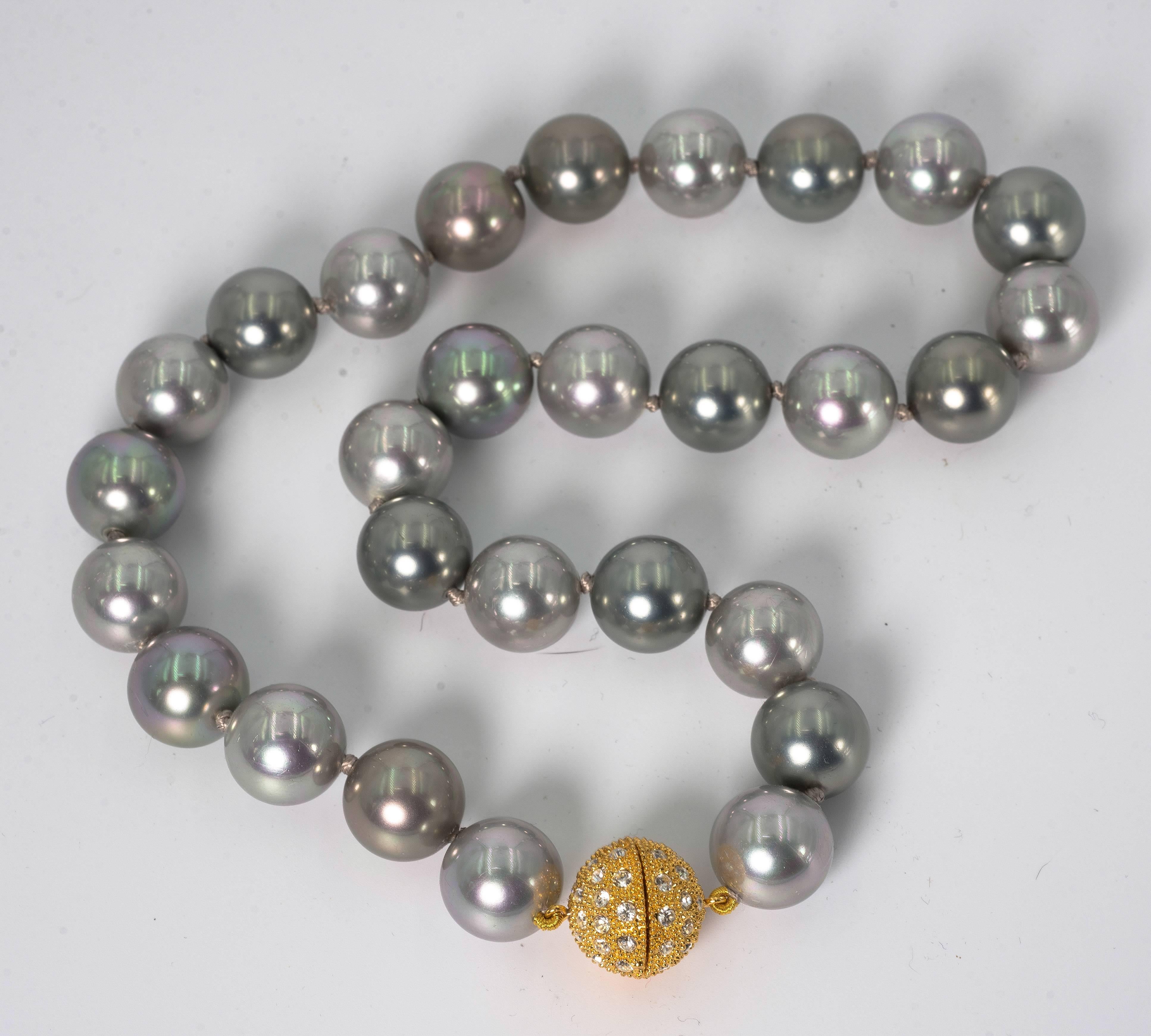 Faux 14mm South Sea Pearl Tahitian Multi Shaded necklace measuring 18’’ to a pave cubic zirconia clasp. Hand silk strung and knotted. These exclusive pearls are made of mother of pearl and have a wonderful lead-free polished luminescent pearl