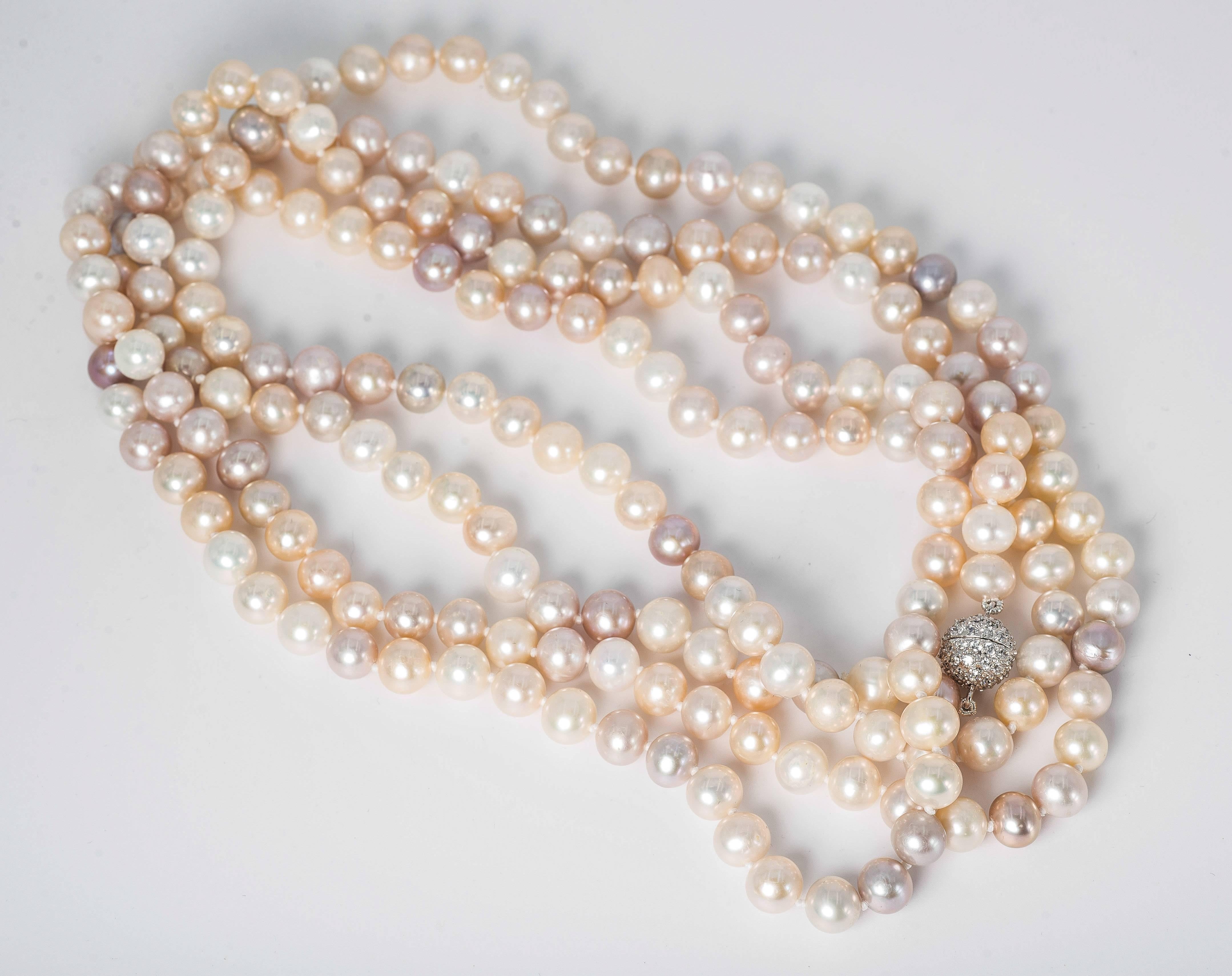 Elegant  Sixty Inch long rope of multi-shaded 8mm real freshwater pearls hand knotted to a pave cubic zircon screw ball clasp. Can be easily wrapped around 4 times a neckline