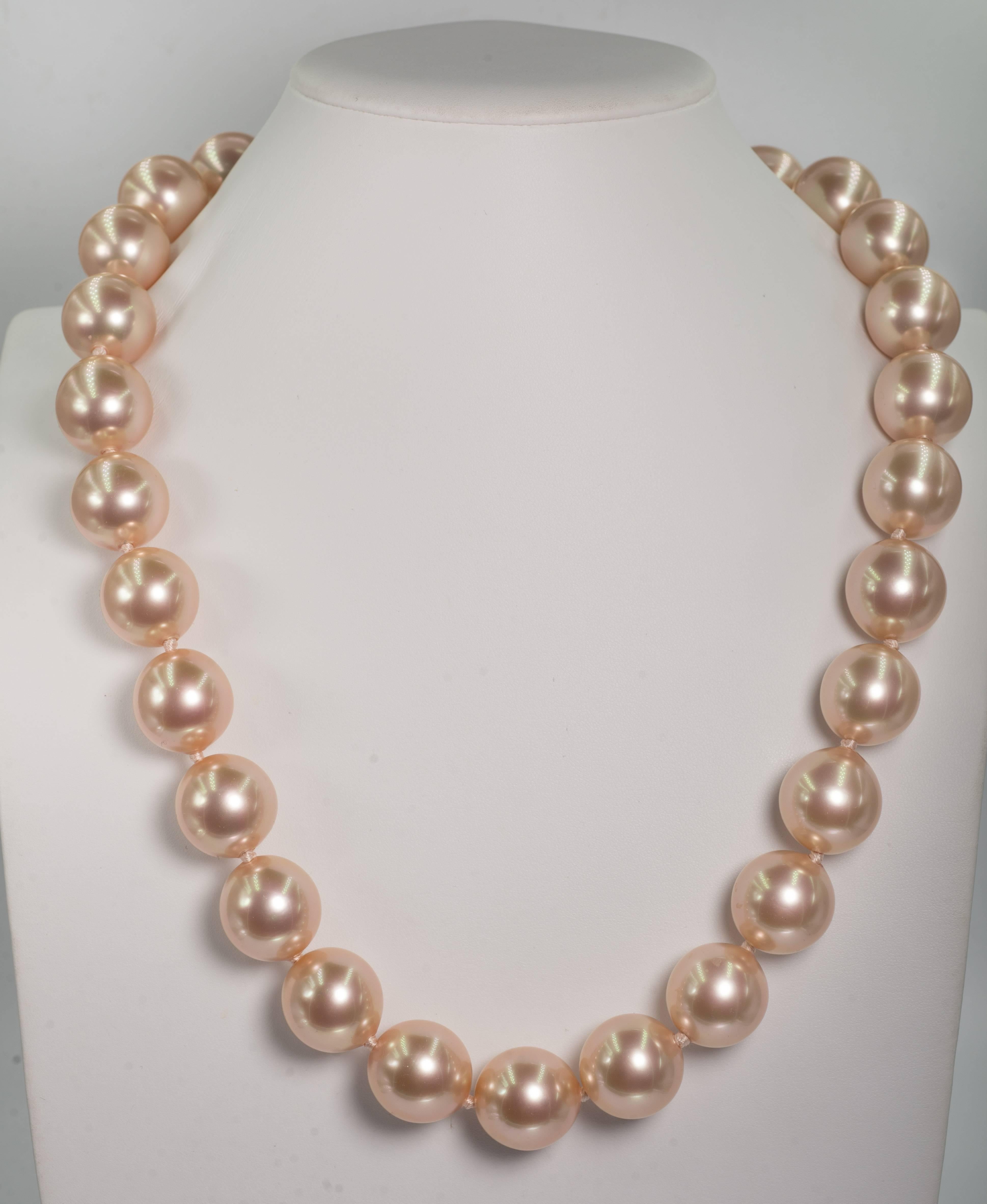 Stunning 26inch faux 20mm French Angel Skin Pink Color handmade pearls by France's oldest faux pearl makers dating back to Napoleon lll. .The pearls are hand strung and knotted to a wonderful pave cubic zircon sterling clasp. These pearls are no