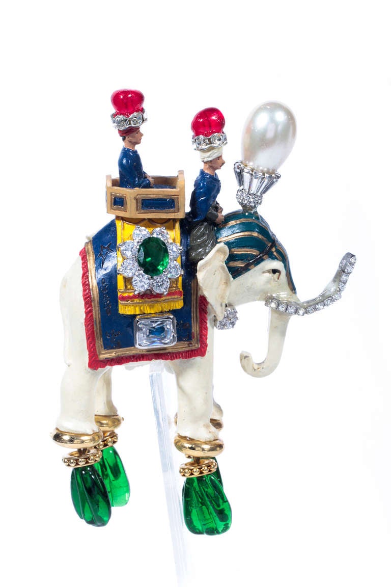 Fabulous Maharajah on elephant brooch. The stately elephant is encrusted with faux diamonds, emeralds, rubies, pearl and has a simply detachable gold chain tassel ornament. Not for the faint hearted as this is the statement piece to end  all