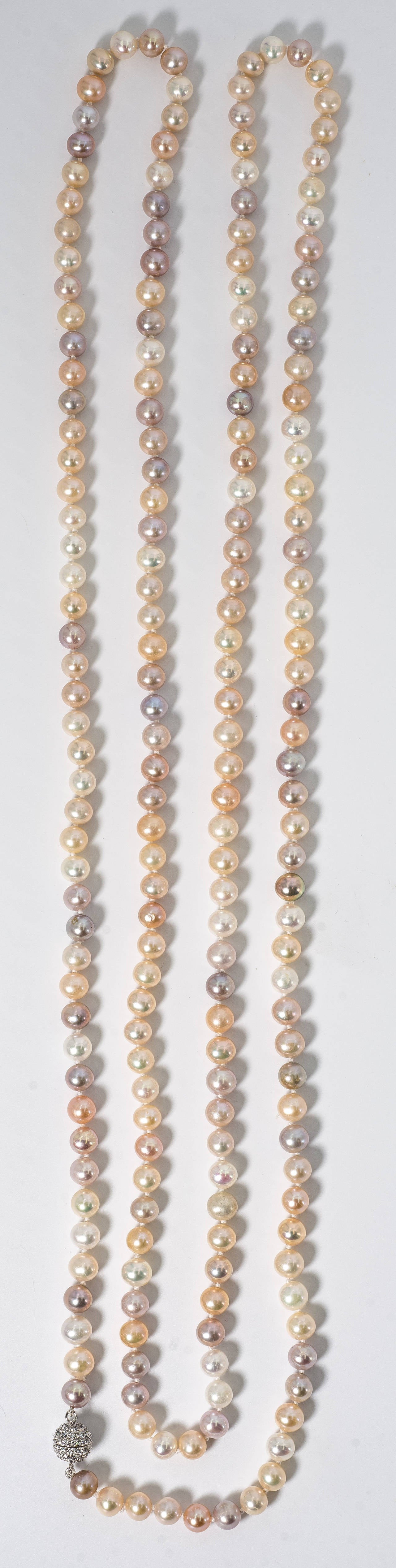 Sixty Inch long rope of multi-shaded 8mm real freshwater pearls hand knotted to a pave cubic zircon screw ball clasp. Can be easily wrapped around 4 times a neckline.