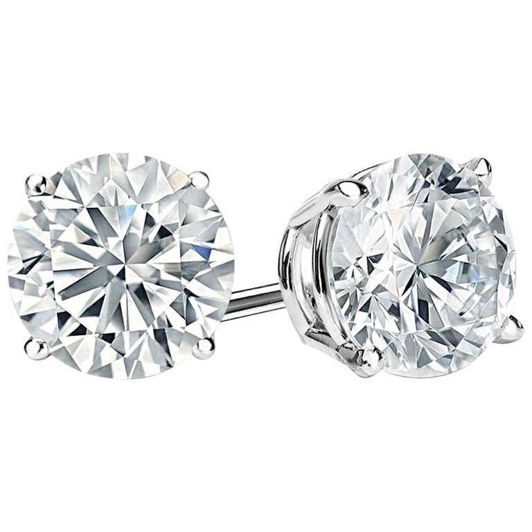 Amazing special diamond cut faux diamonds 6 carats each studs set in rhodium sterling silver. These are the finest ever made modern cut round faux diamonds of cubic zirconia. Half an inch diameter. Total real diamond carat weight look would be 12