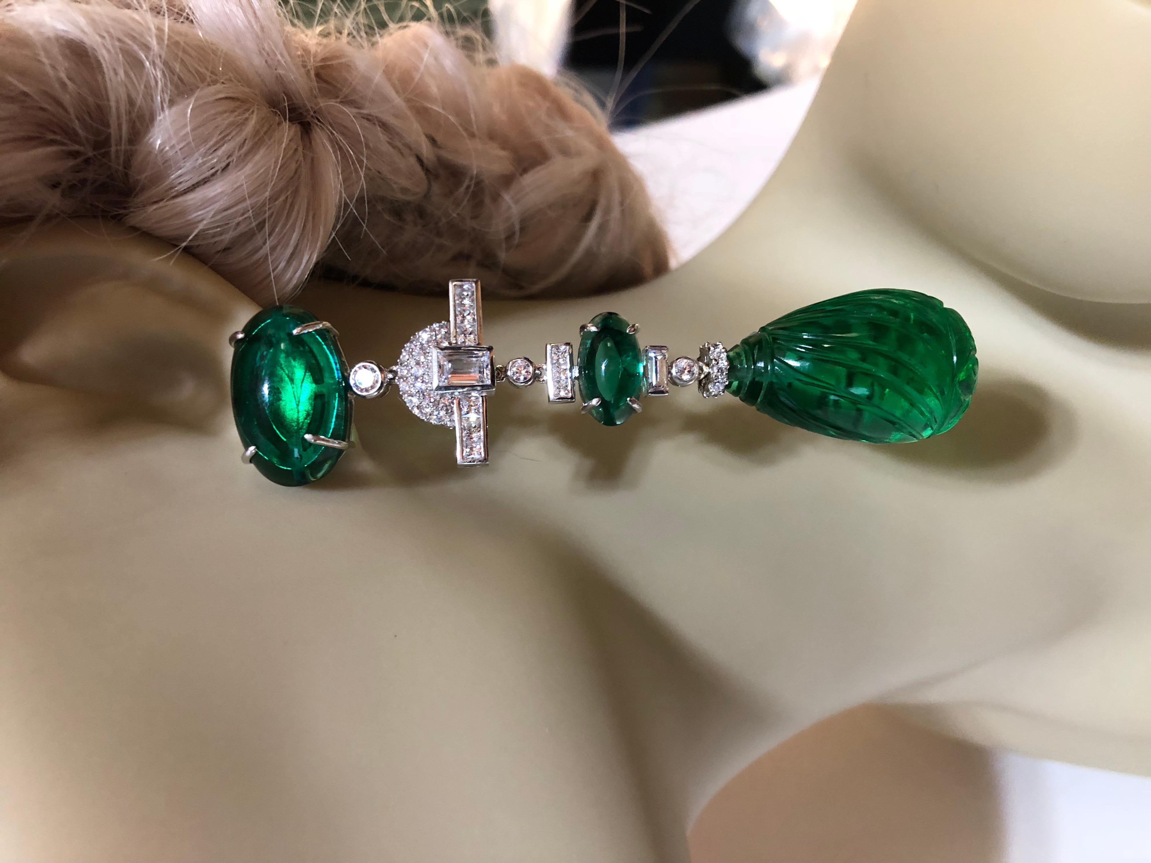 Amazing faux diamond large cabochon emerald earrings. The round tops are 8 carats each diamond weight, the squares are about 4 carats each and the pear cabochon faux Colombian green emeralds are about 40 carats each. Two inches long. Sterling silver