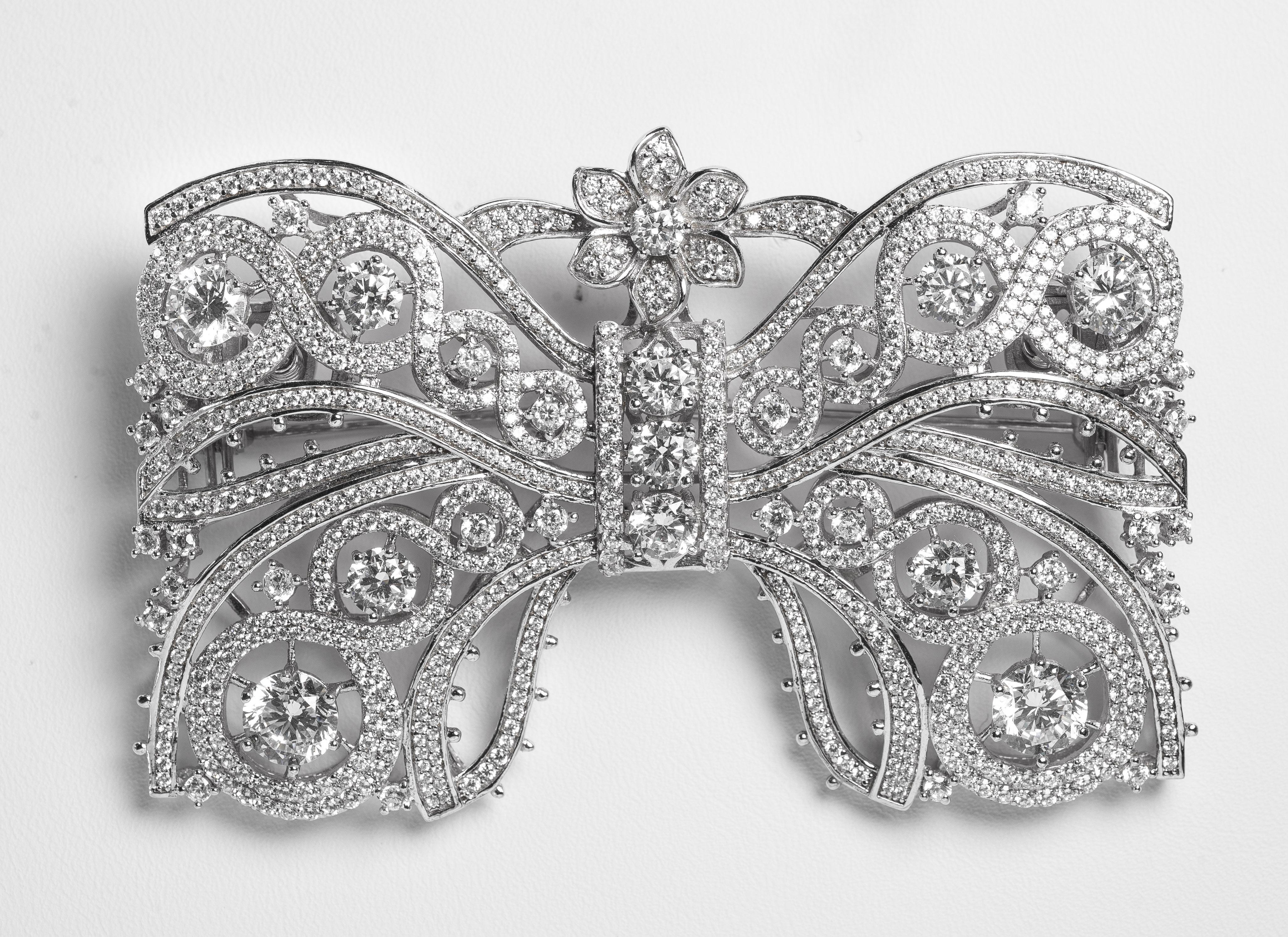 Marie Antoinette Collection garland style large faux diamond bow pin micro pave cubic zircons set in rhodium sterling makes this large 3'' wide by 2'' deep very much a statement jewel. Quite amazingly real looking and the very best quality.
Please