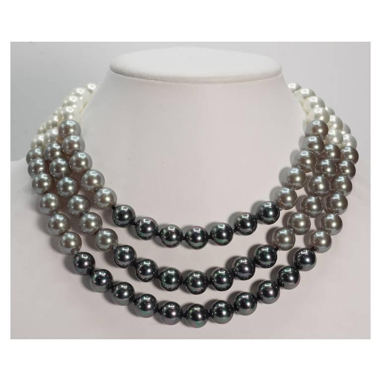 Elegant Triple Strand Shaded White Tahitian Black Faux Pearl Necklace of finest handmade Japanese polished glass 12mm pearls silk hand-strung inside row 18'' to outside row 20'' CZ set sterling flexible clasp. Two inches deep. All our pearls were