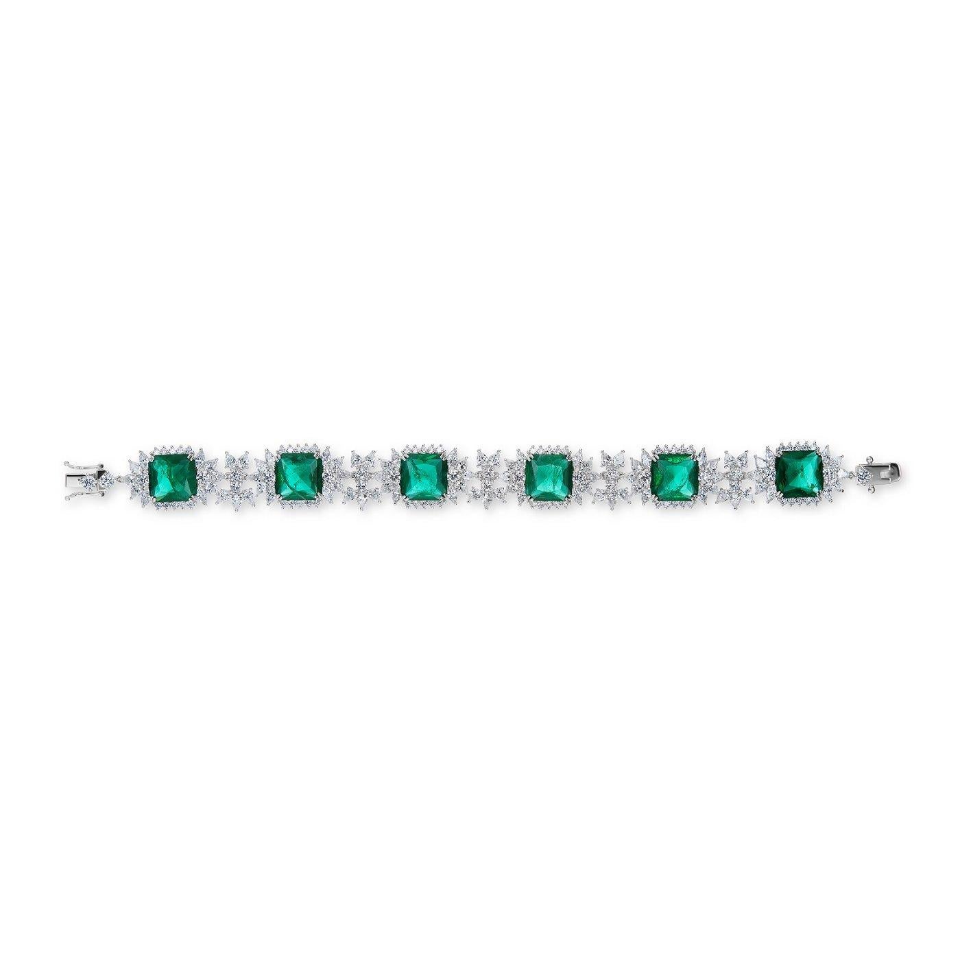 Magnificent Costume Jewelry faux Colombian emerald diamond bracelet set with  4 carat  square cut faux emeralds  diamonds surrounded by white marquise and round CZ stones set in rhodium sterling 7 inches long.
Elegant and delicate.
