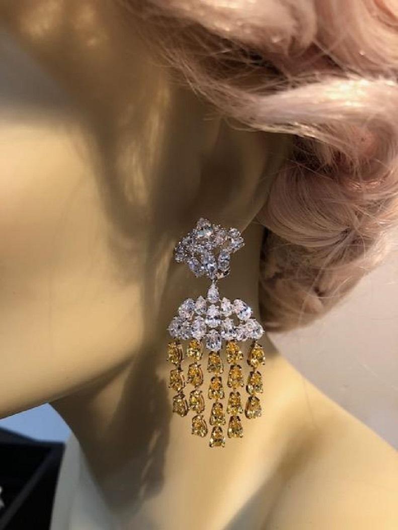 Magnificent Costume Jewelry faux marquise and pear shape white and canary cubic zirconia waterfall chandelier earrings made of scintillating CZ all flexible shimmering and chic! Hand made in rhodium sterling clip/post measure 2.50 inches long by 1