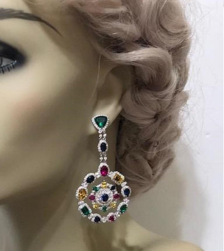  Magnificent Costume Jewelry multi -color gem wreath chandelier circle earrings set with different cut synthetic emeralds, rubies, sapphires, yellow and white diamonds set in rhodium sterling. Post fitting 3 inches long by 1.50 inches wide