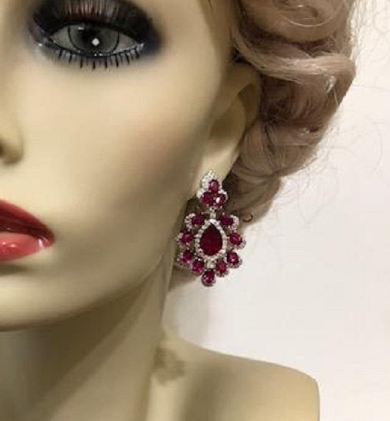  Faux ruby cubic zirconia Peacock earrings set in rhodium sterling with detailed micro pave and intense faux rubies. Clip post 2 inches long by 1 inch wide. Extremely chic.