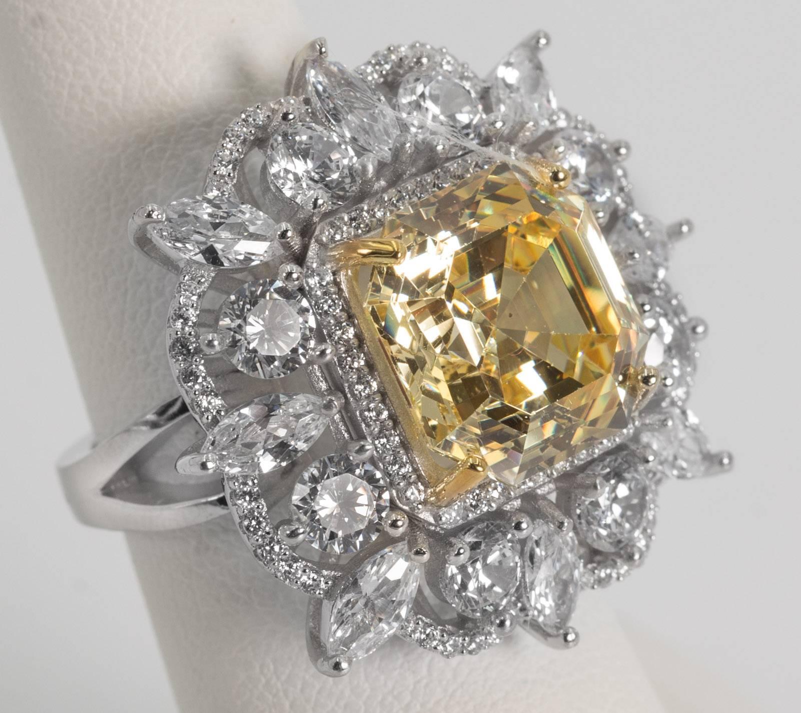 
A 15 carat fancy intense canary yellow hand special cut emerald cut cubic zirconia nestled amongst fancy cut white faux diamonds set in sterling designed to the highest fine standards possible. A classic amazing sparkly and brilliant look that will