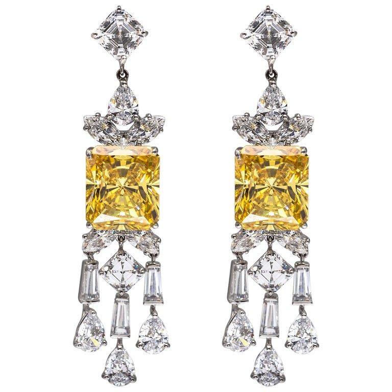 A pair of stunning faux canary yellow and white cubic zircon sterling earrings.
The intense canary stones are equivalent to 8 carat diamonds surrounded by bright white cubic zircons all set like the finest real diamond jewelry.
21/2'' long  x 1/2''