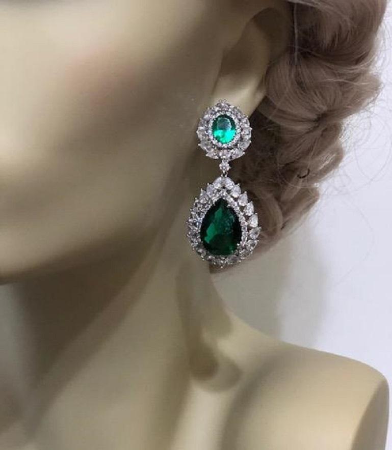 Magnificent Costume Jewelry stunning diamond emerald drop earrings set with the finest synthetic gemstones and marquise cubic zirconia in rhodium sterling silver clip/post  2 inches long by one inch wide.