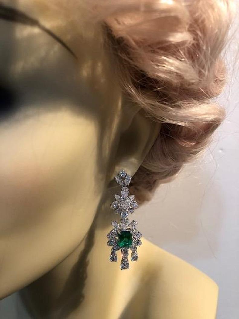 Magnificent Costume Jewelry synthetic emerald diamond delicate chandelier earrings set with marquise, pear shape and round CZ with faux emerald in rhodium sterling measures 2 inches long.
