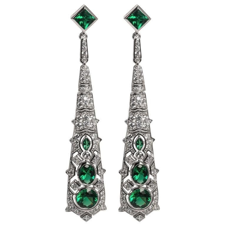 Wonderful faux emerald diamond earrings of synthetic stones hand set in sterling silver in the manner of the elegant Art Deco period. Superbly well made.

Measure 3 inch long by 1/2 inch wide with post fitting.

