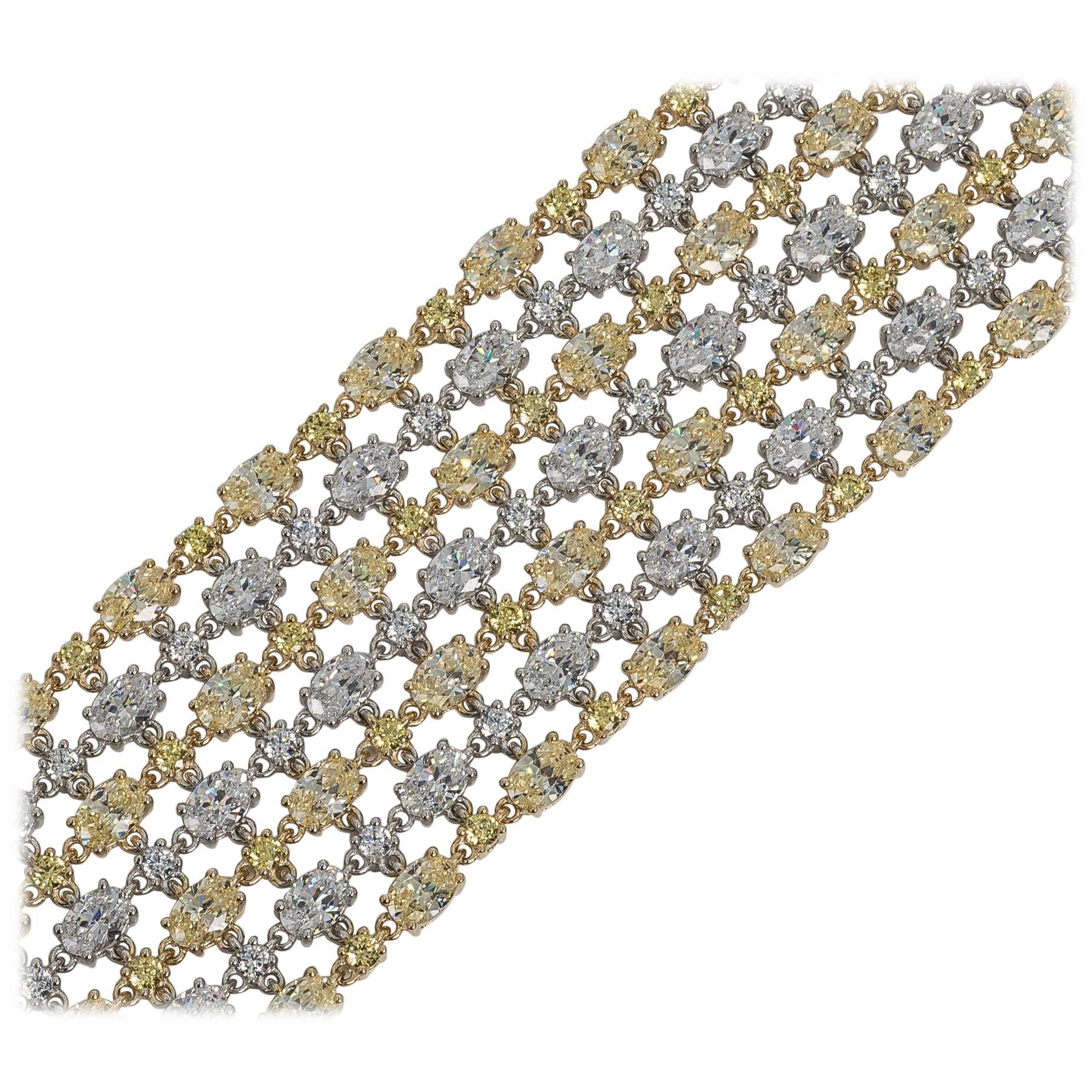 White and yellow cubic zirconia mesh costume jewelry bracelet made of hand-cut canary yellow and white rhodium sterling set oval and round cubic zirconia. Amazing fine quality guaranteed to look like the real. Seven and half inches long by one and a