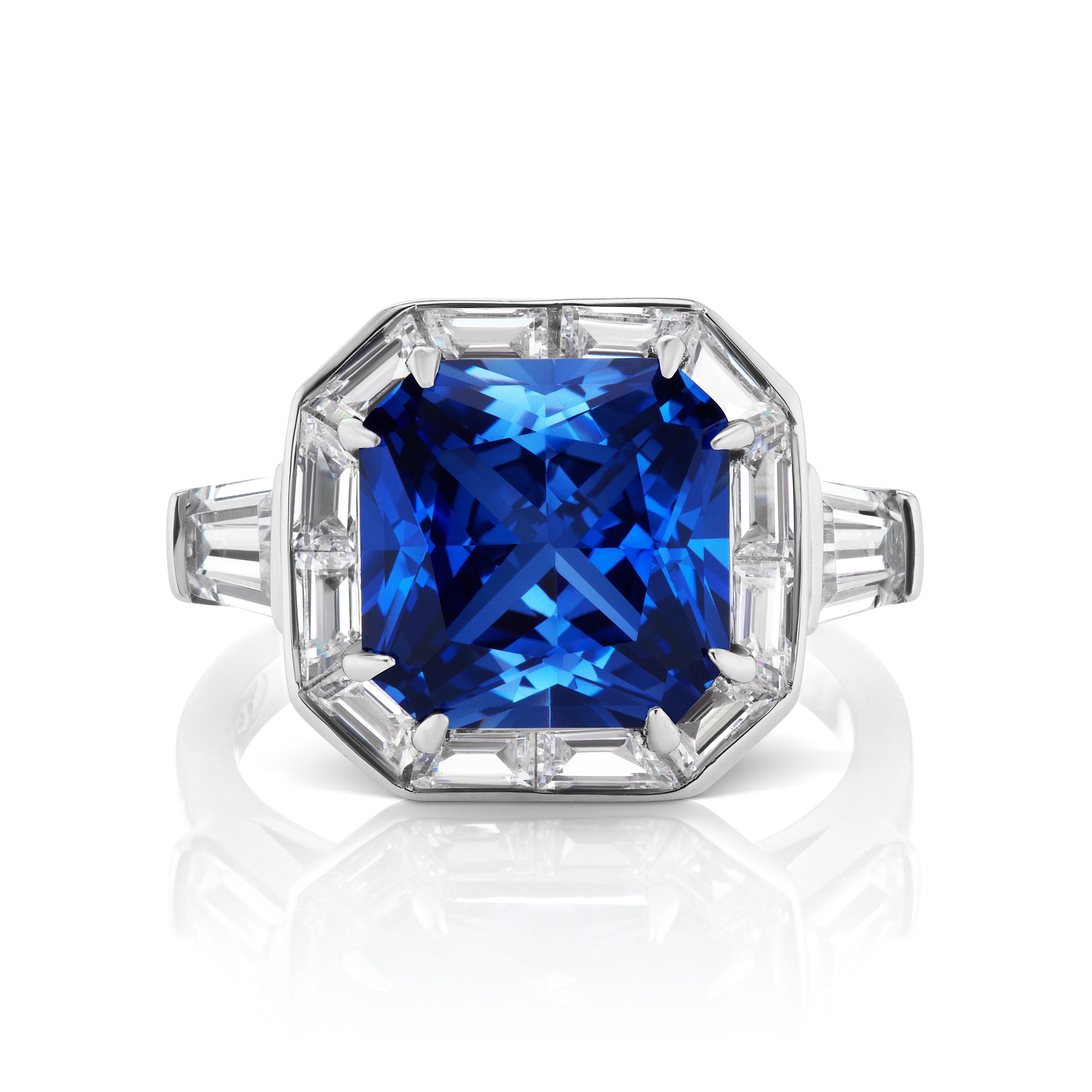 Magnificent Costume Jewelry Art Deco Style Square Man-Made Sapphire Cubic Zirconia Diamond Halo Style Silver Ring Bordered with Cubic Zirconia Fancy-Cut Baguettes and Tapers on the Shank.  Center 'sapphire' looks a like a 5 carat, bright Ceylon. The