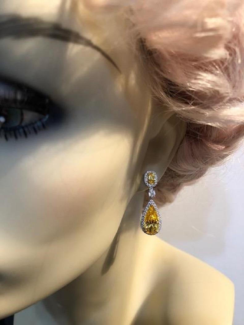 Magnificent  Costume Jewelry Charming Faux canary yellow cubic zirconia diamond sterling earrings.
Beautiful contrast of intense canary yellow edged with micro set white stones. Post only. Discreet and very real-looking. 1 1/4inches long