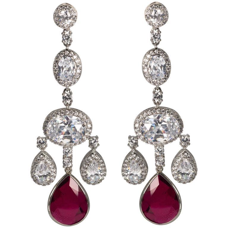 Faux diamond ruby shimmering girandole chandelier earrings made of the finest hand set man-made gems. Totally real looking glamorous faux jewelry, light as a feather, flexible and post fitting measures 3'' long by 1'' wide.