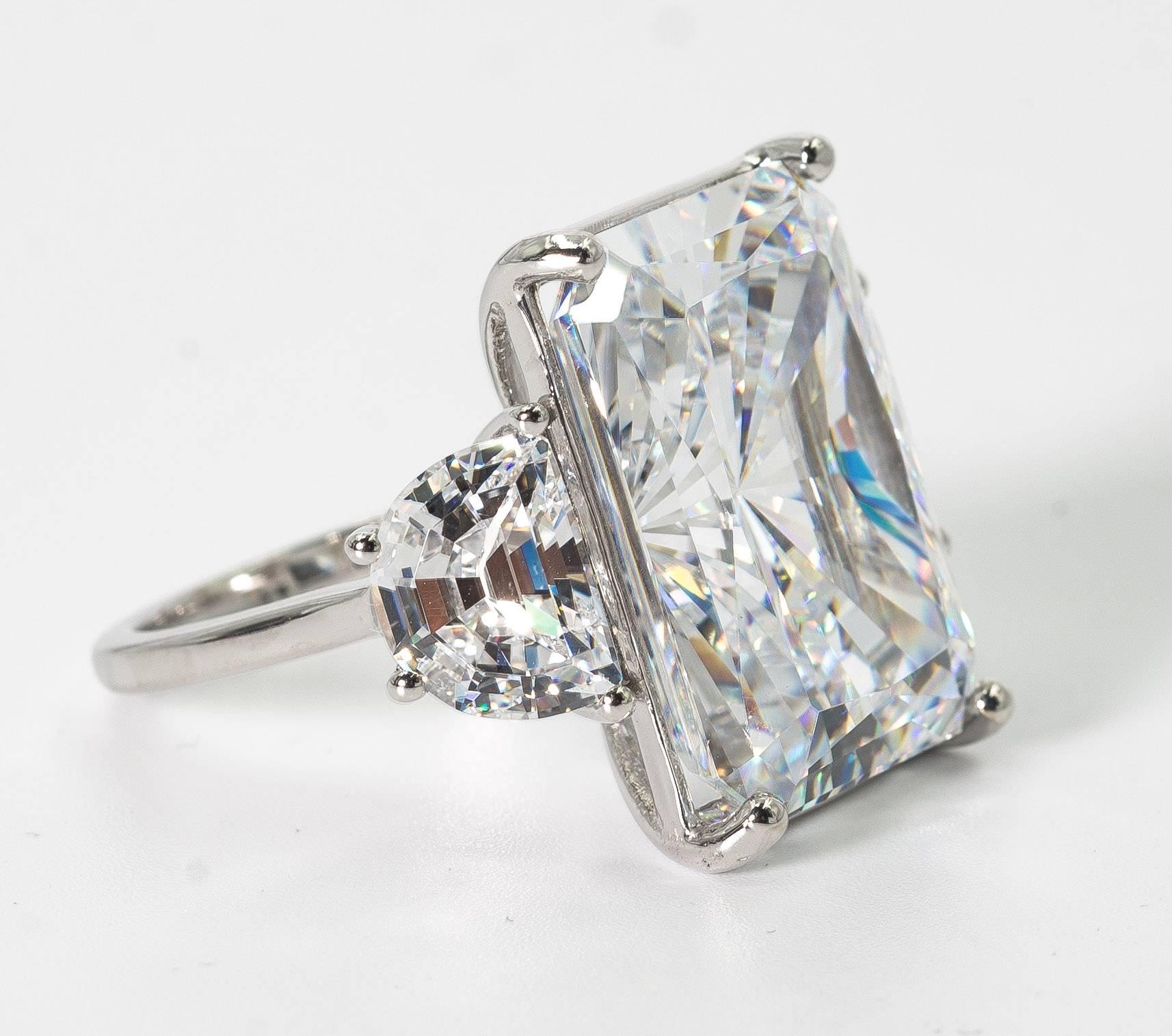 Magnificent faux white 25 carat Radiant Cut diamond ring set with classic half moons side stones. The radiant cut cubic zircon is a wonderful high quality white color that reflects and sparkles exactly like a gem!
Measures 7/8th inch by 6/8th inch.
