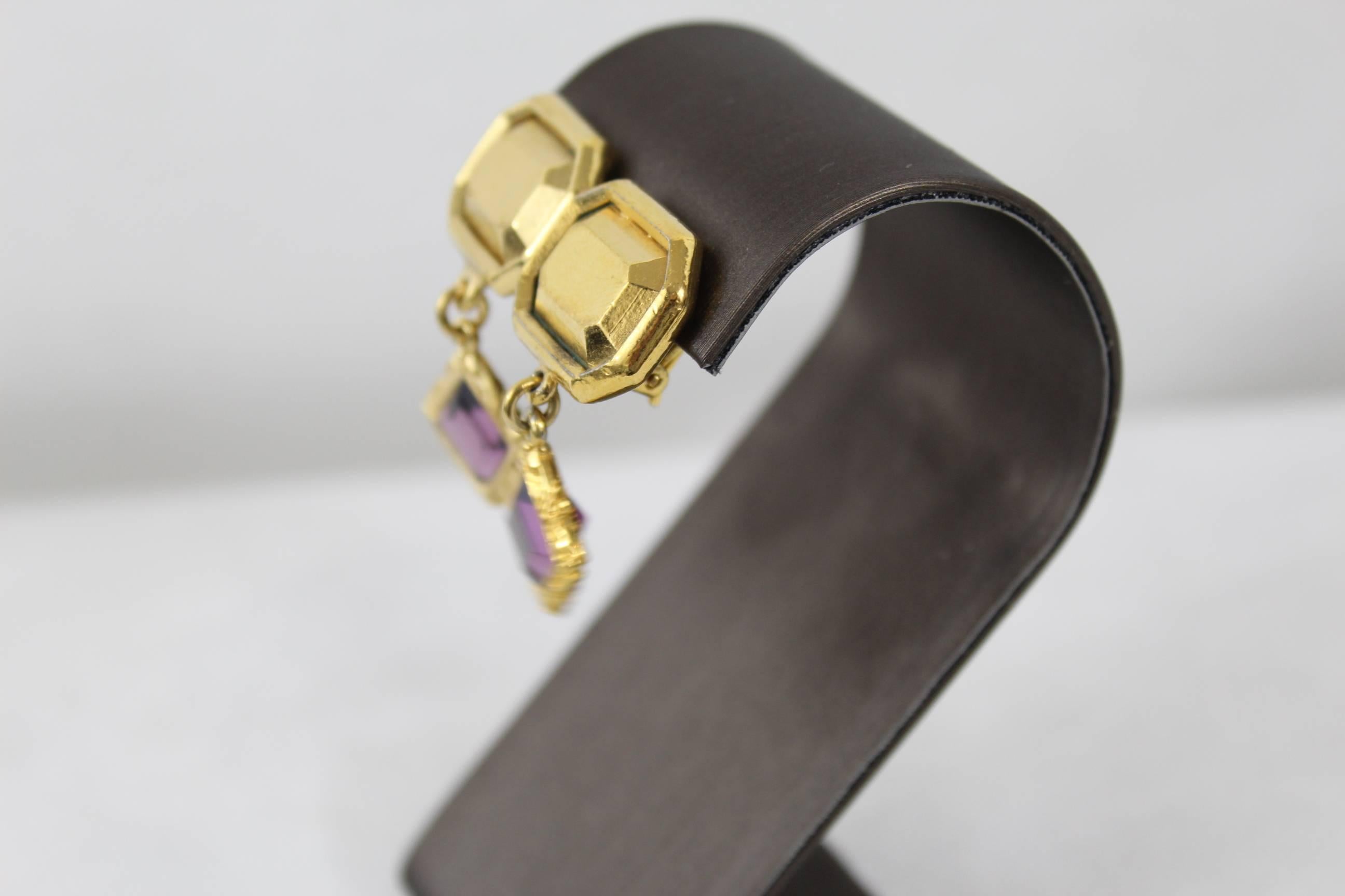Really nice pair of YSL vintage earrings with purple stone.

Some signs of wear but overall nice condition
