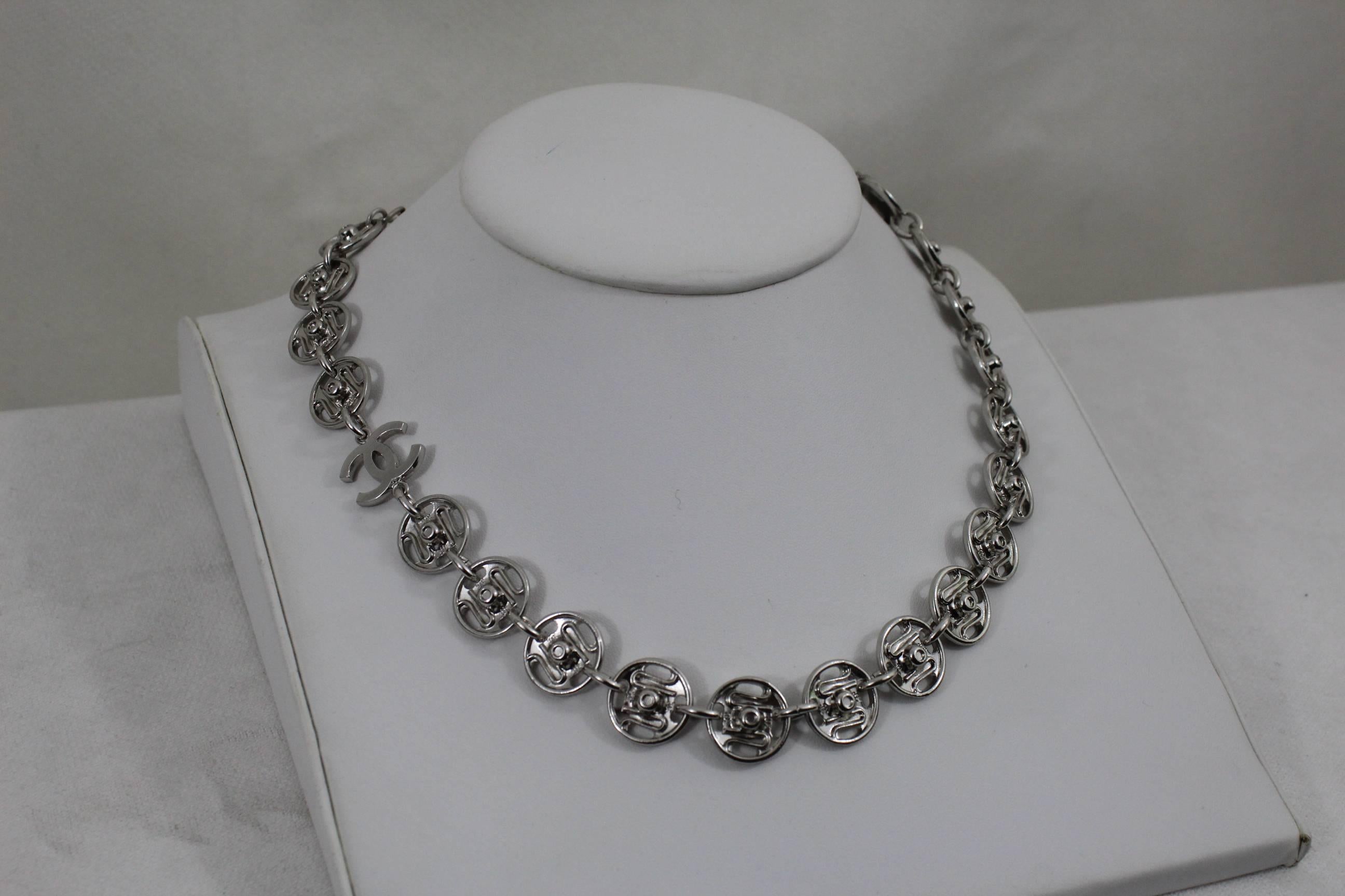 One already sold, this is the last one available.

Nice Chanel Necklace in stainless steel with charms representing pression buttons.

This have been seen in the catwalk during the fashion show.

Total lenght 22 inches