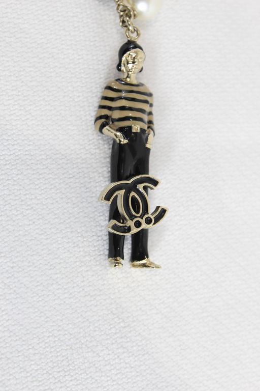 Chanel Fake Pearls and Charms Necklace with Chanel Doll Pendant at
