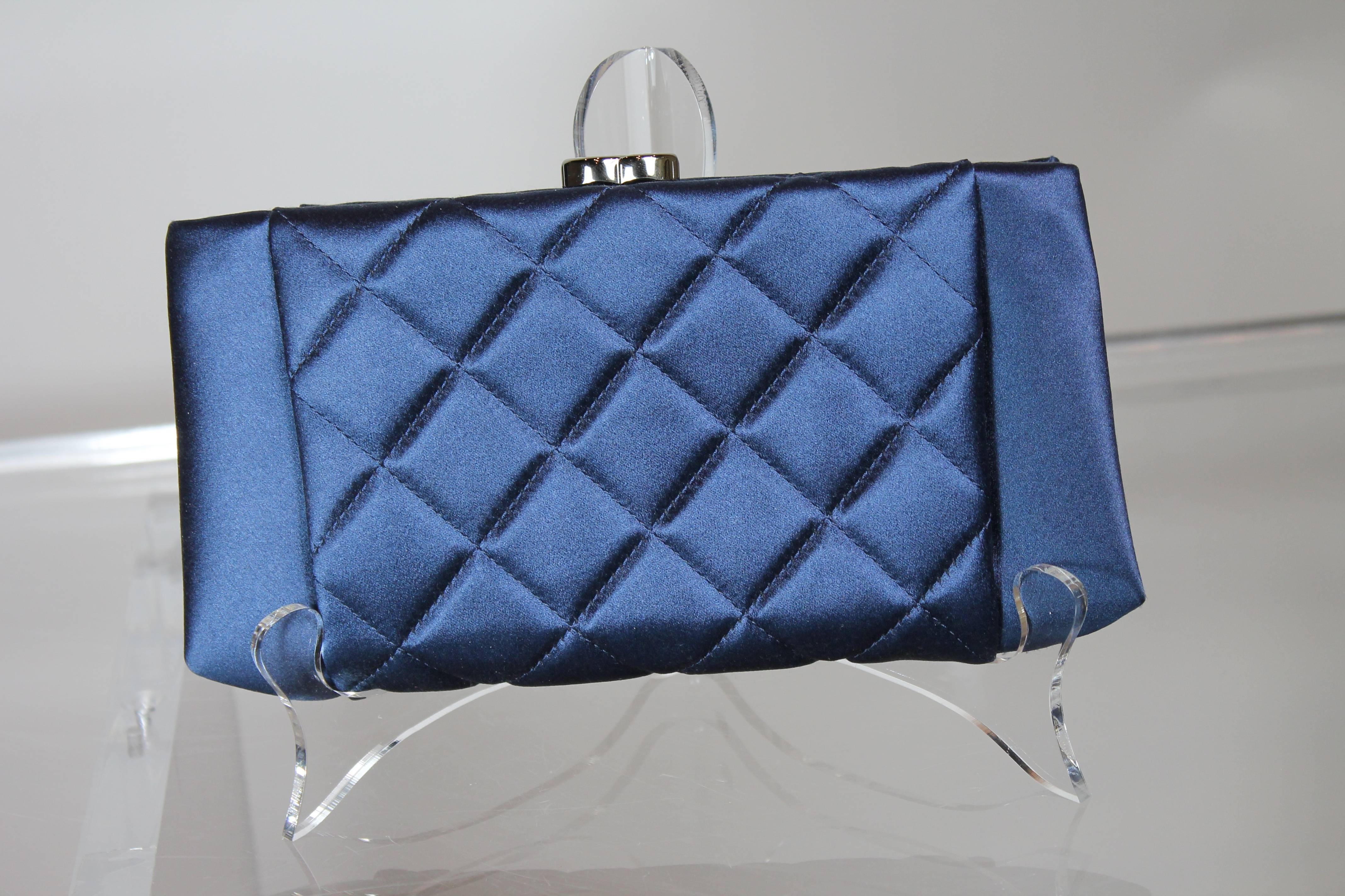 Chanel gives us the essential evening accessory with this clutch bag in navy blue quilted satin. 
Gunmetal hardware includes 