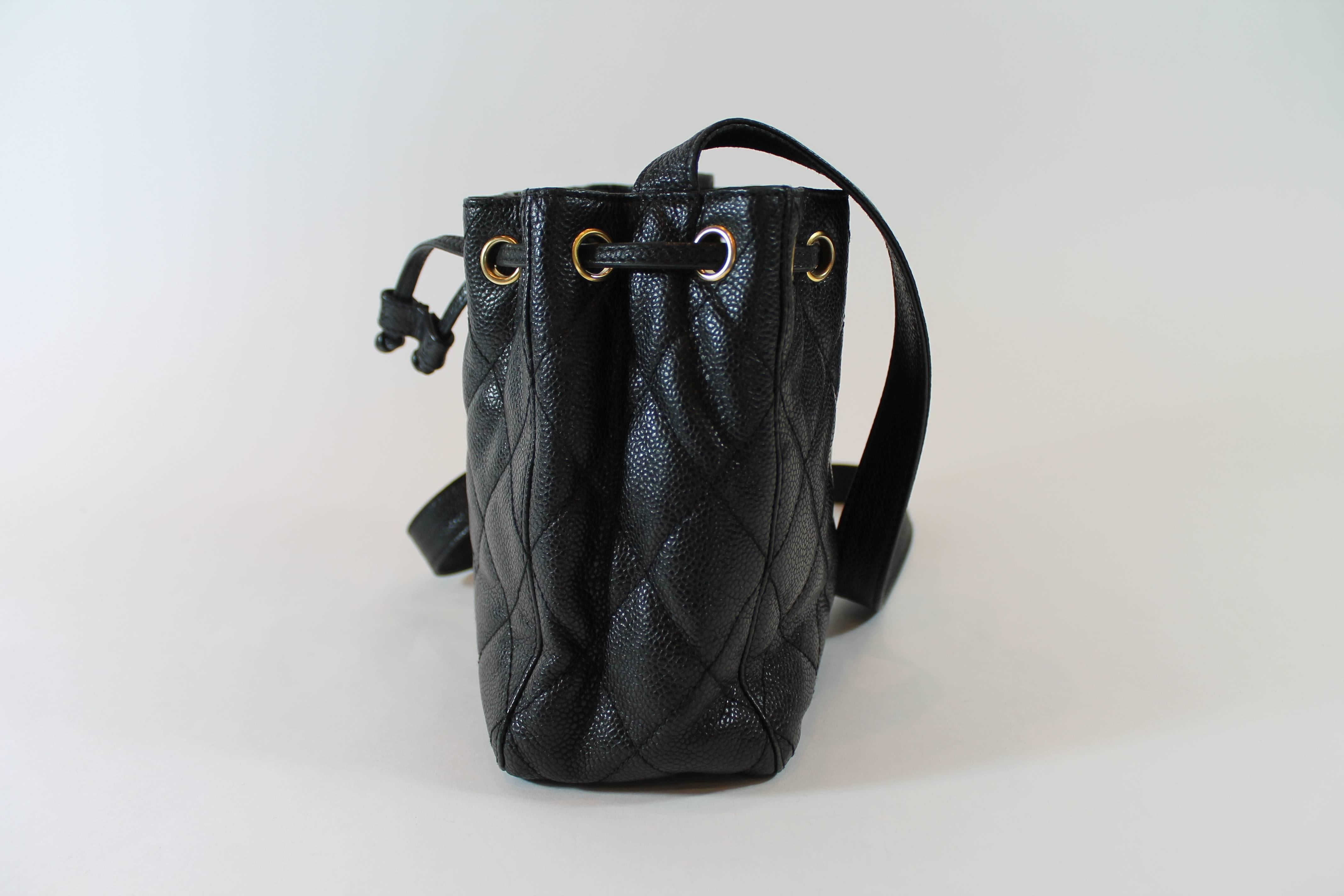 Chanel vintage bag for the absolute Chanel lovers! This adorable Chanel drawstring bag can be worn over the shoulder or as a short cross body. Black caviar quilted leather with gold-tone hardware. Two interior zippered pockets. Black silk ribbed