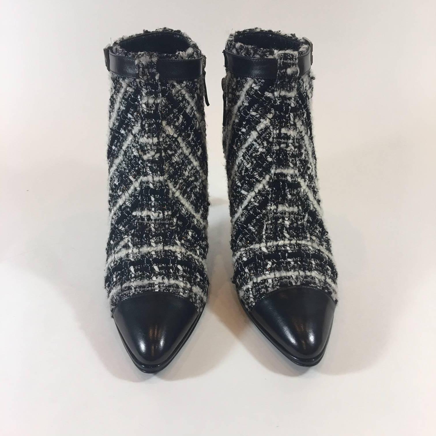 Stand tall in these stunning Chanel Boucle tweed ankle boots. Black leather toe, shiny patent heel and decorative black leather side buckle. Size zipper.  Size 40. Made in Italy. Never Worn. 3.5
