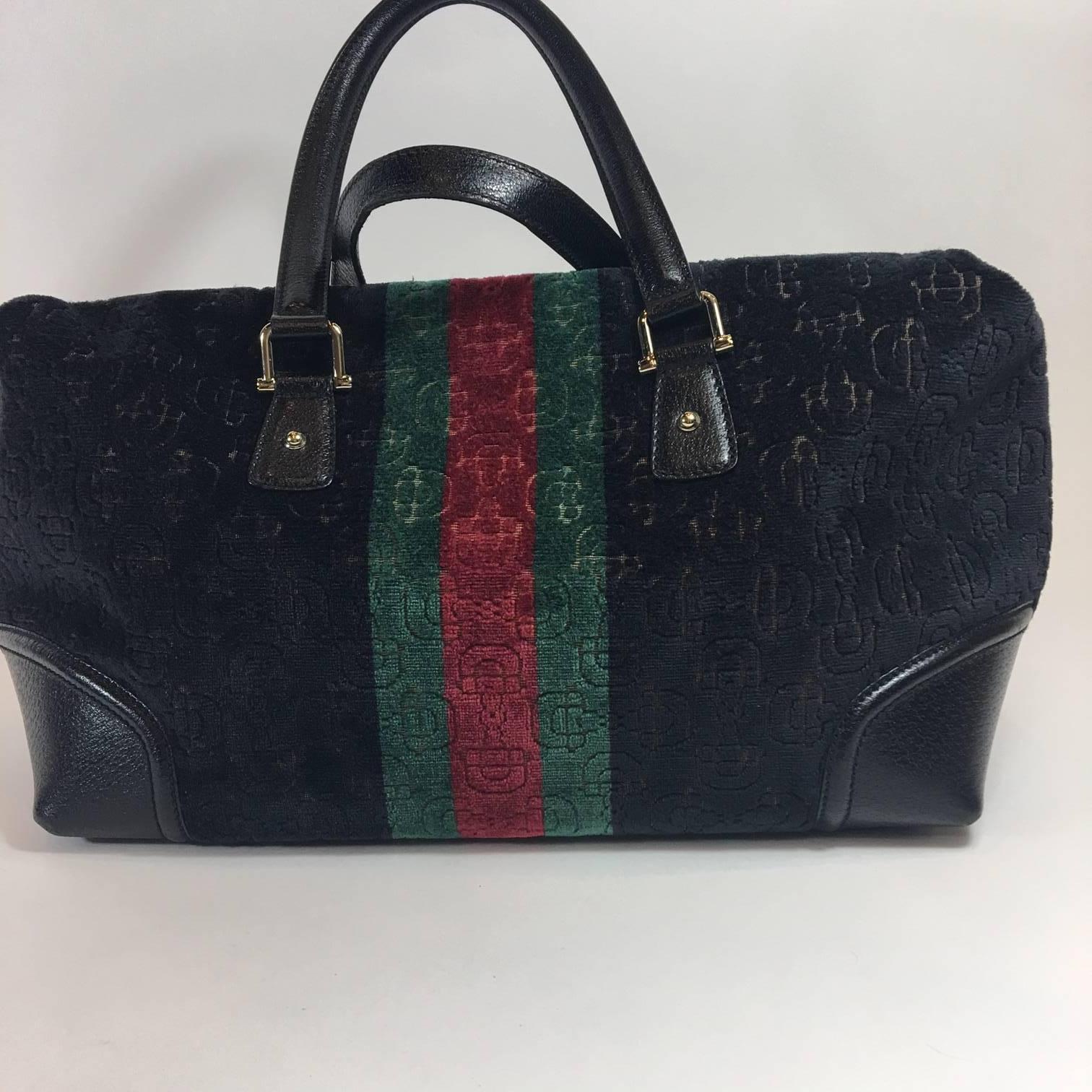 Fall/Winter will have you grabbing hold of this classic beauty. Gucci Treasure Boston bag in the perfect size for every day use. Black velvet with classic green and red center stripe - fabric is soft, horsebit embossed velvet with black leather