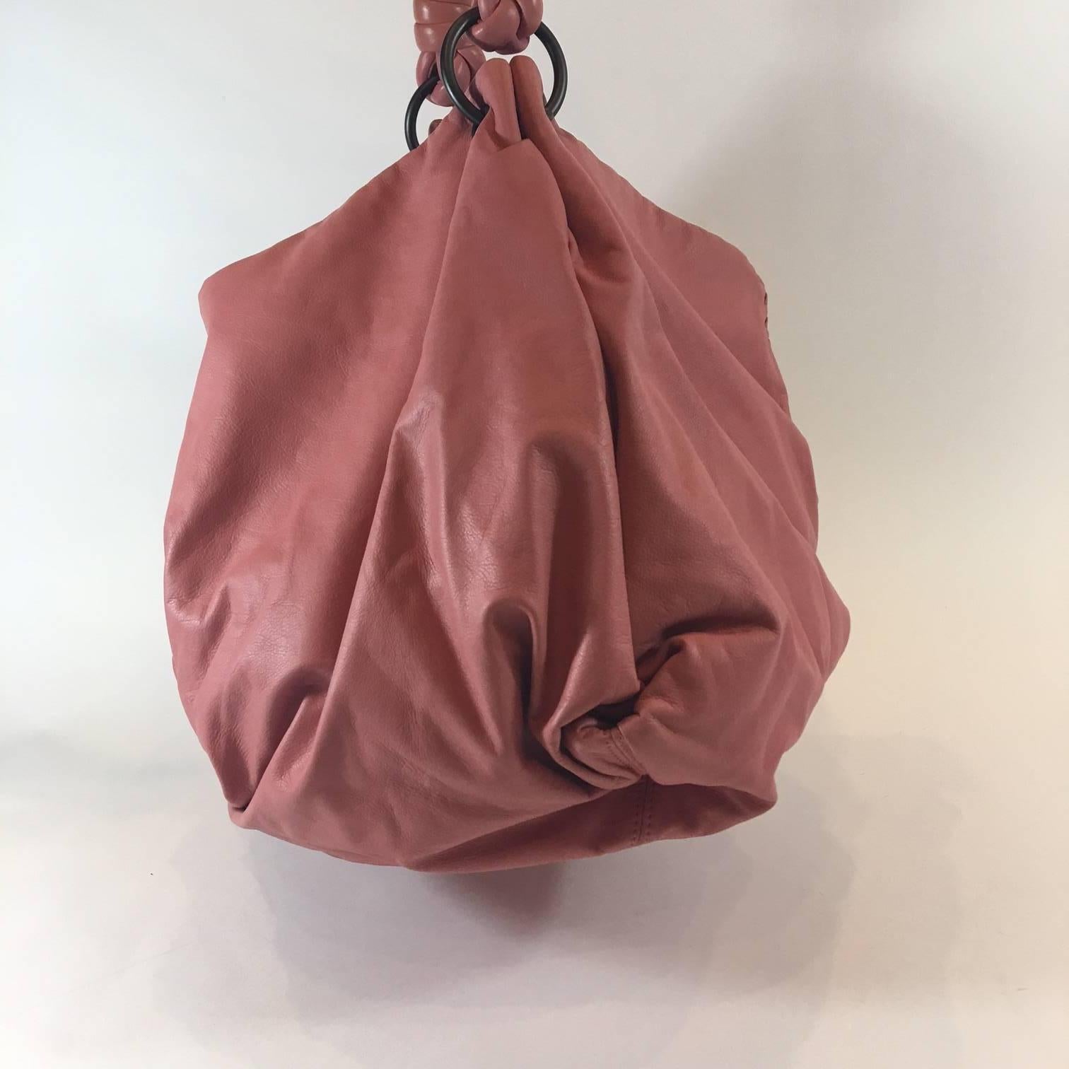 This soft and luxurious Bottega Veneta bag is known as the Petal Woven Leather Aquilone Fortune Cookie Hobo Bag. Made in Italy and featuring Bottega's signature intrecciato woven leather details in a pale pink 